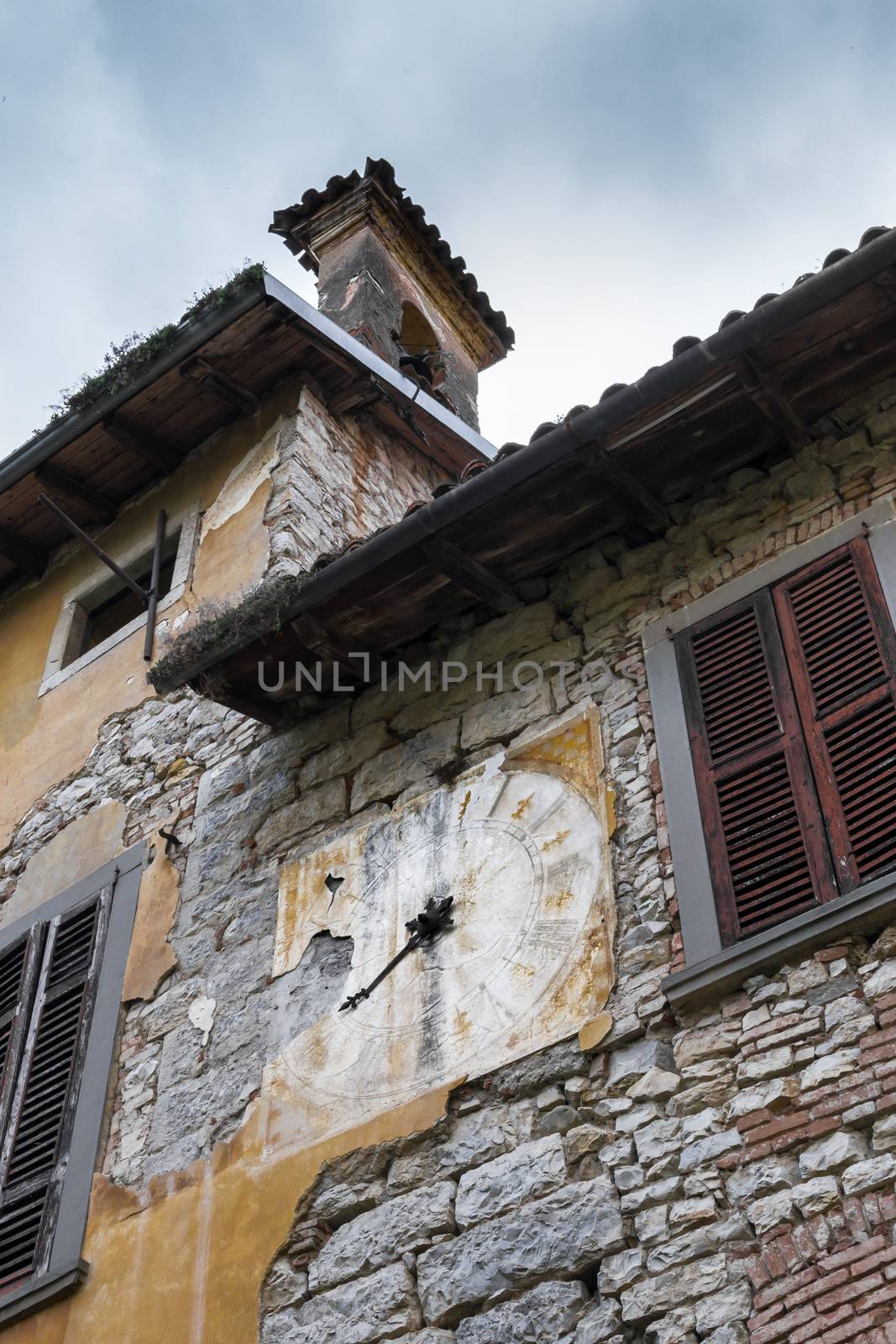 Medieval clock on a facade of house