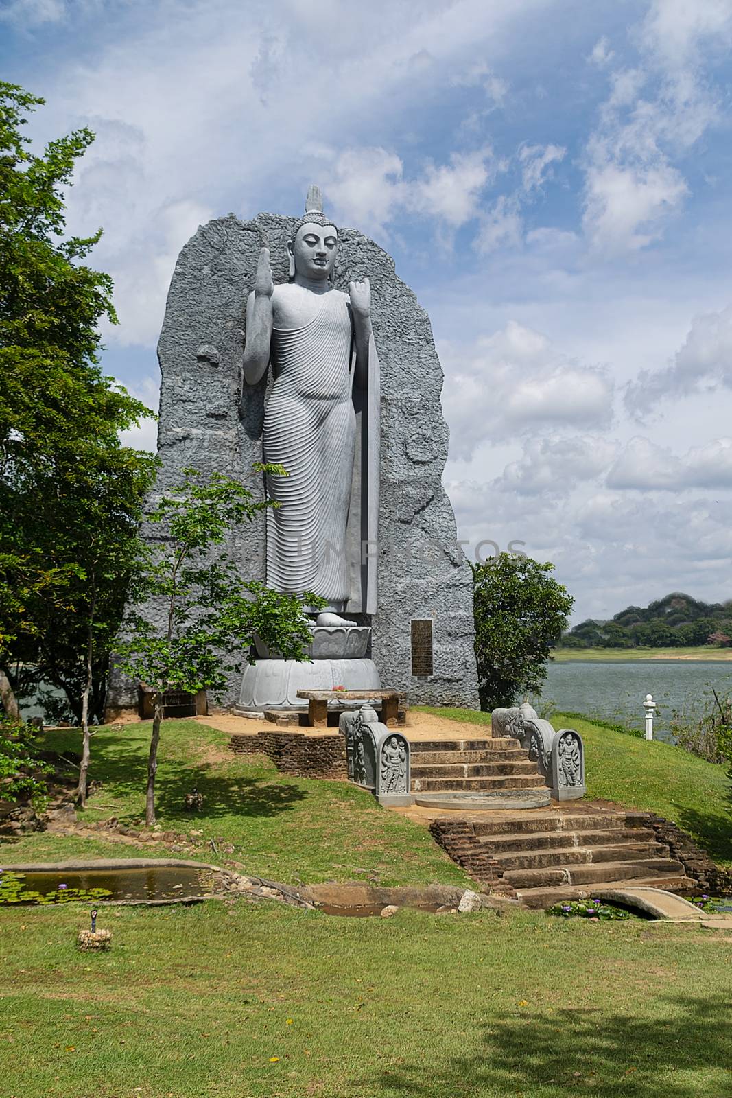 Polonnaruwa, Sri lanka, Sept 2015: Replica of Aukana Buddha statue and Giritale Wewa lake, Giritale near Polonnaruwa