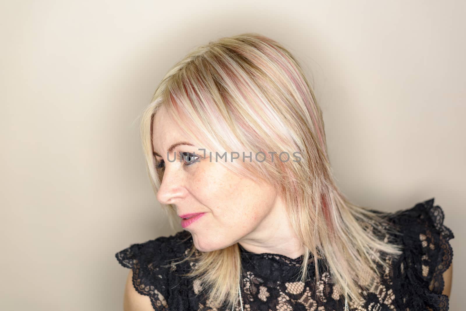 Uk, Leicestershire - Jan 2017 - Caucasian woman mid 40's with pink dye in hair wearing a black top