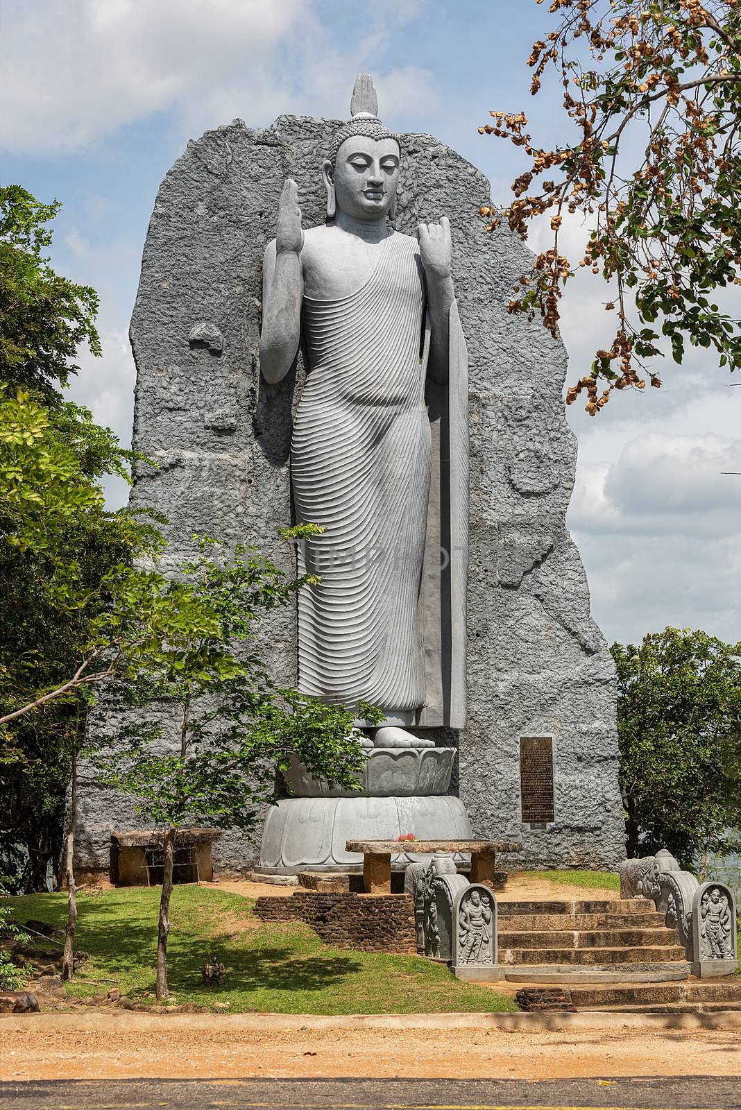 Polonnaruwa, Sri lanka, Sept 2015: Replica of Aukana Buddha statue and Giritale Wewa lake, Giritale near Polonnaruwa