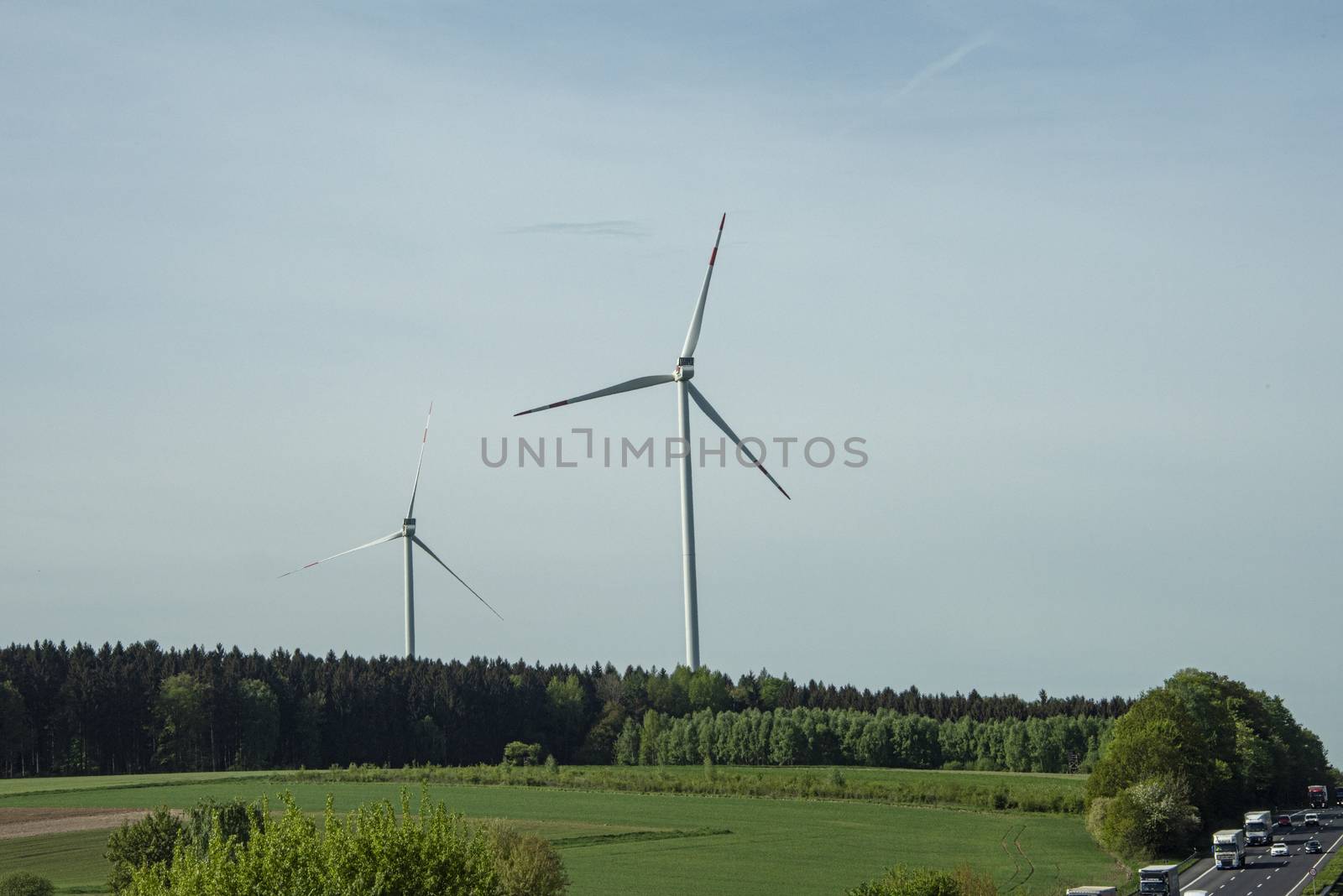 DE, North Rhine-Westphalia - April 2018: Pair of Wind turbines or power windmills over the Germany country side