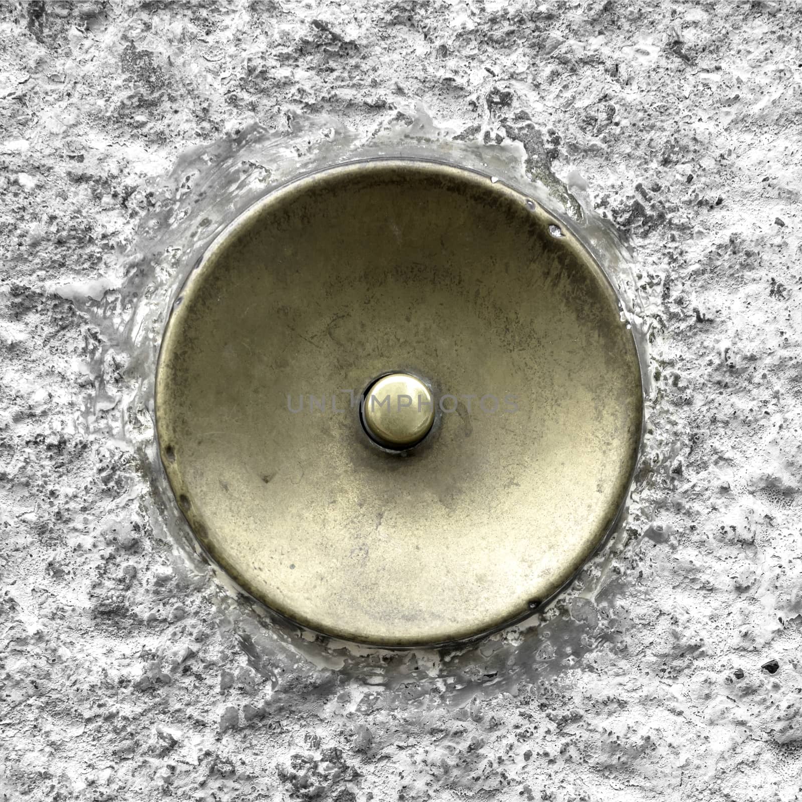 Extrem close-up of an antique brass doorbell, oxidized by the time.