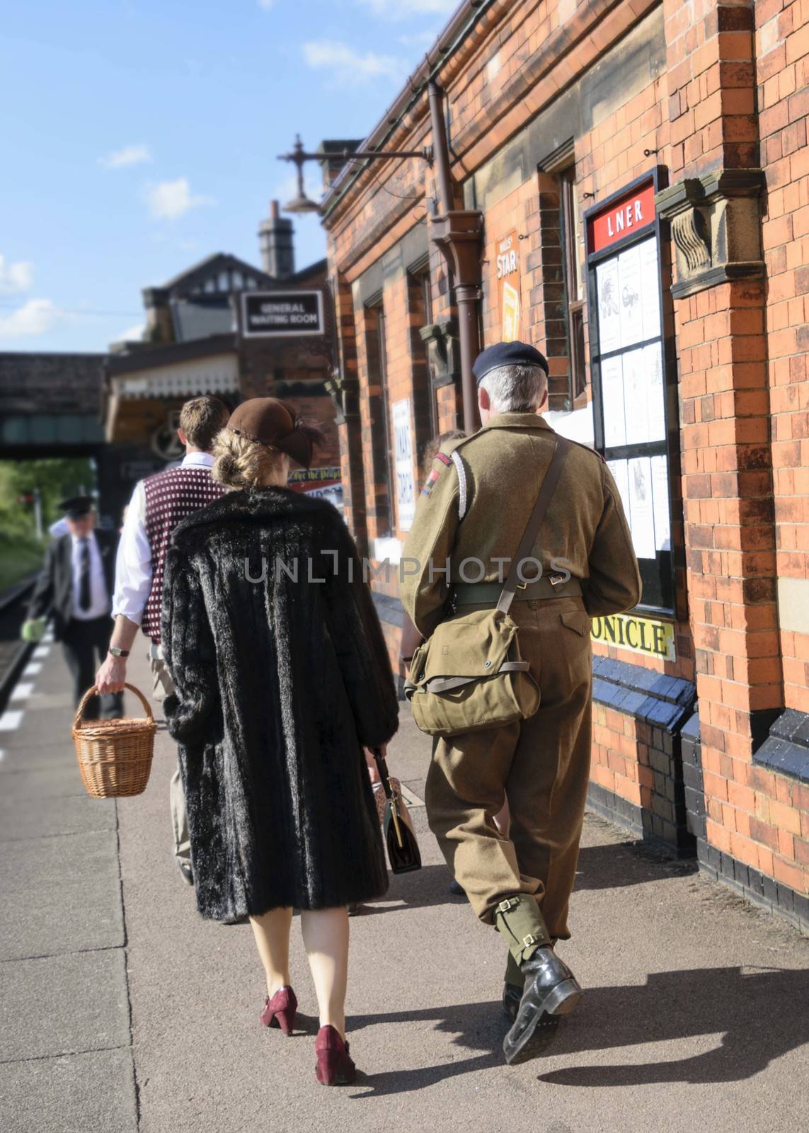 UK, Quorn - June 2015: People in war time dress on train platform
