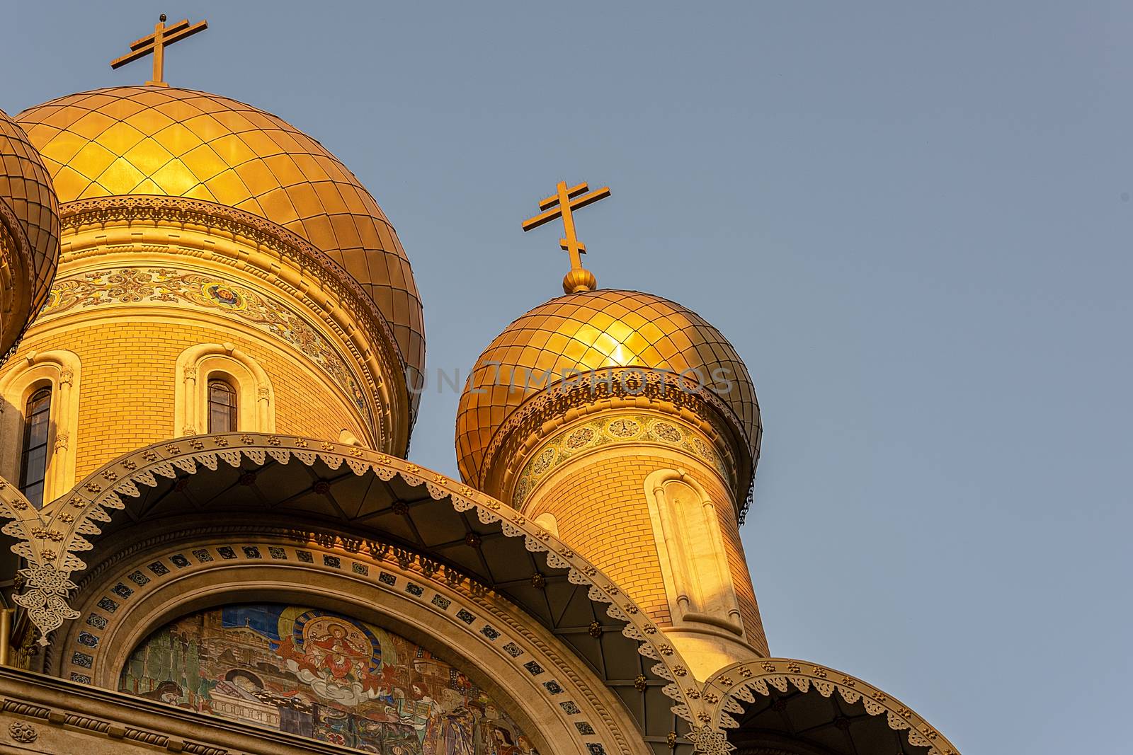 Bucharest, Romania - Aug 2019: Sun refecting off the golden minarets of  St. Nicholas Russian Church in old town Bucharest, Romania.  Located just off University Square, in process of restoration. Built in 1905-1909.