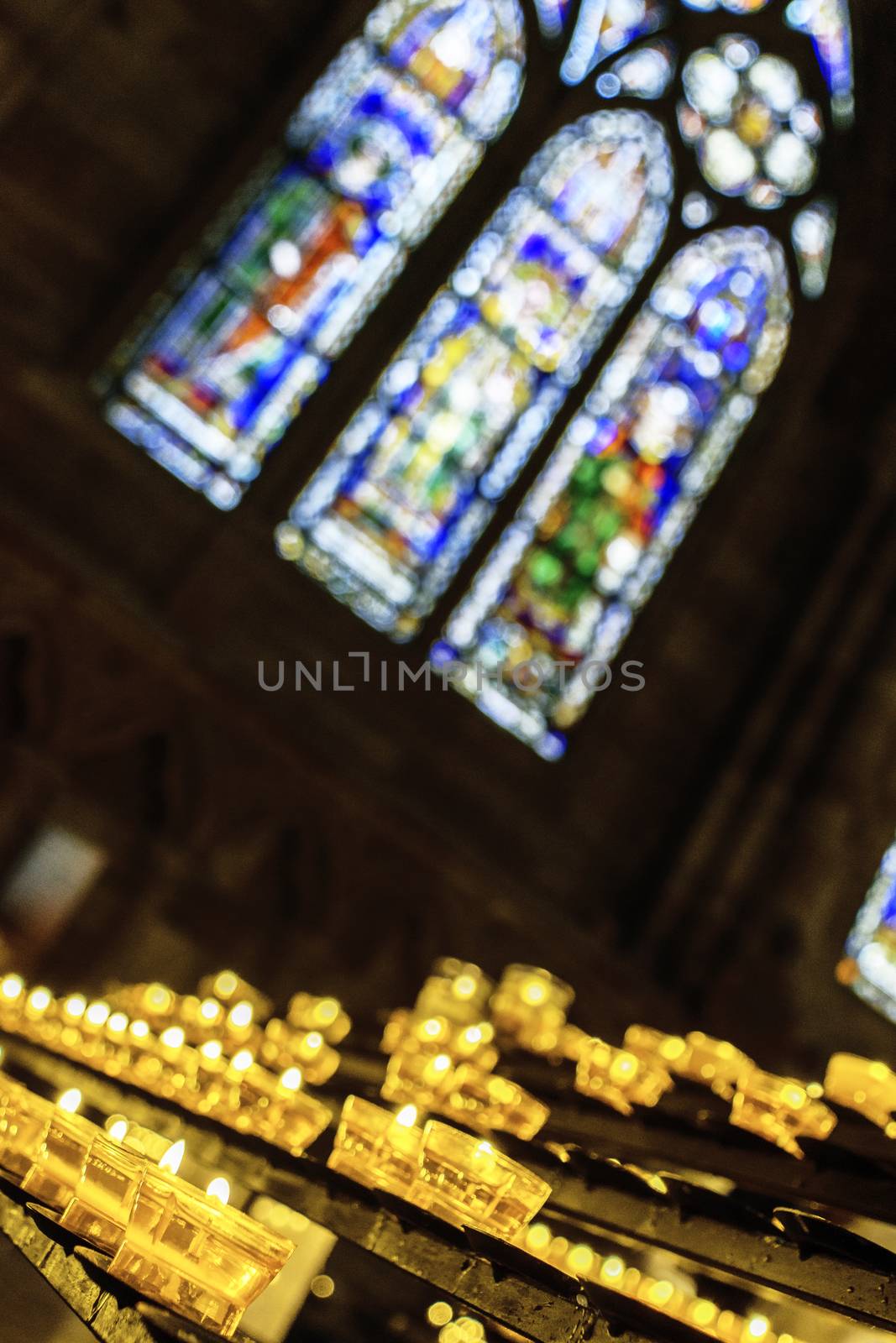 France, Alsace, June 2015: offering candles burning in cathedral