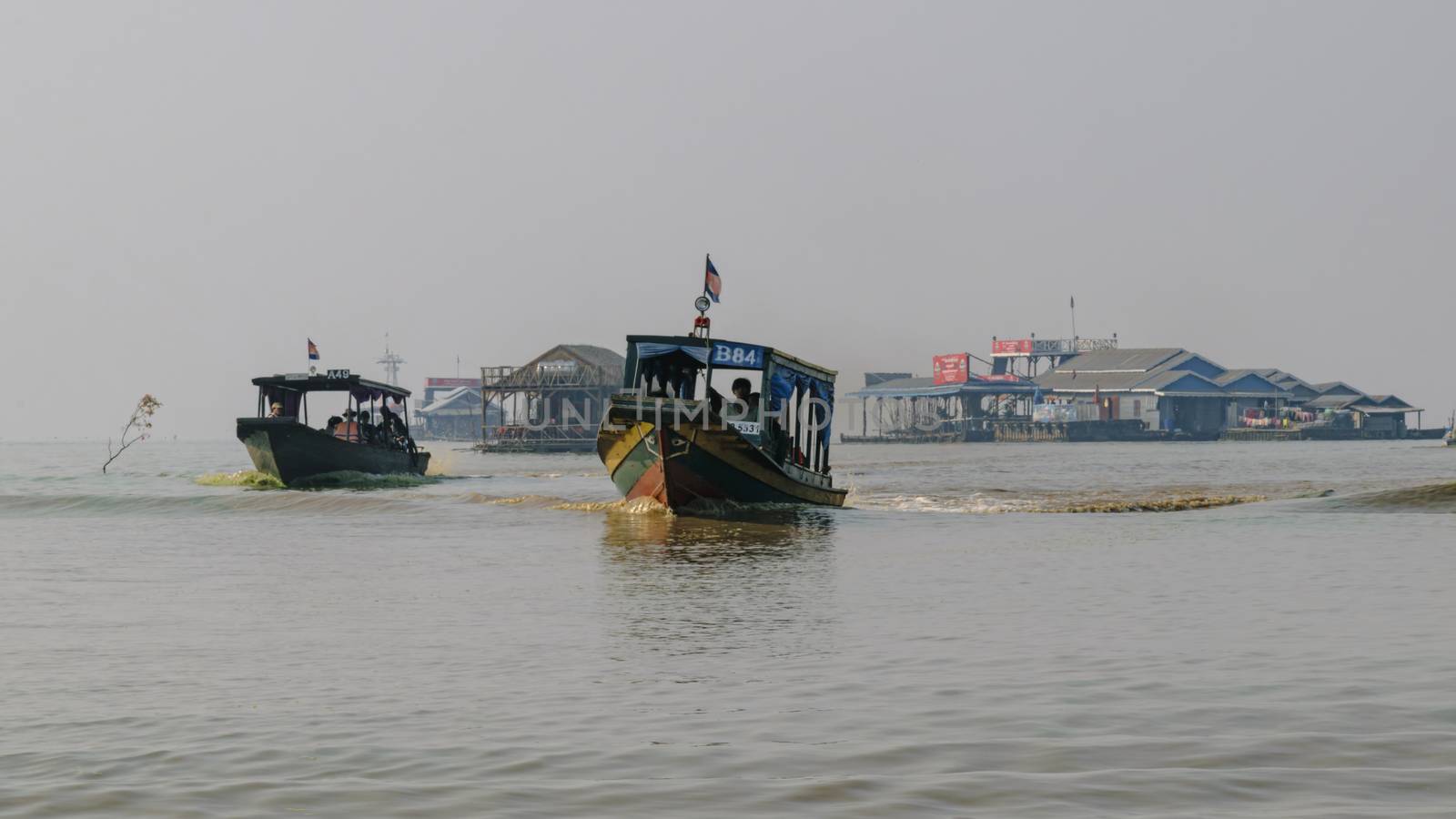 Cambodia, Tonle Sap Floating Village - March 2016: The water buses shuttle people to and from their destinations in the floating village