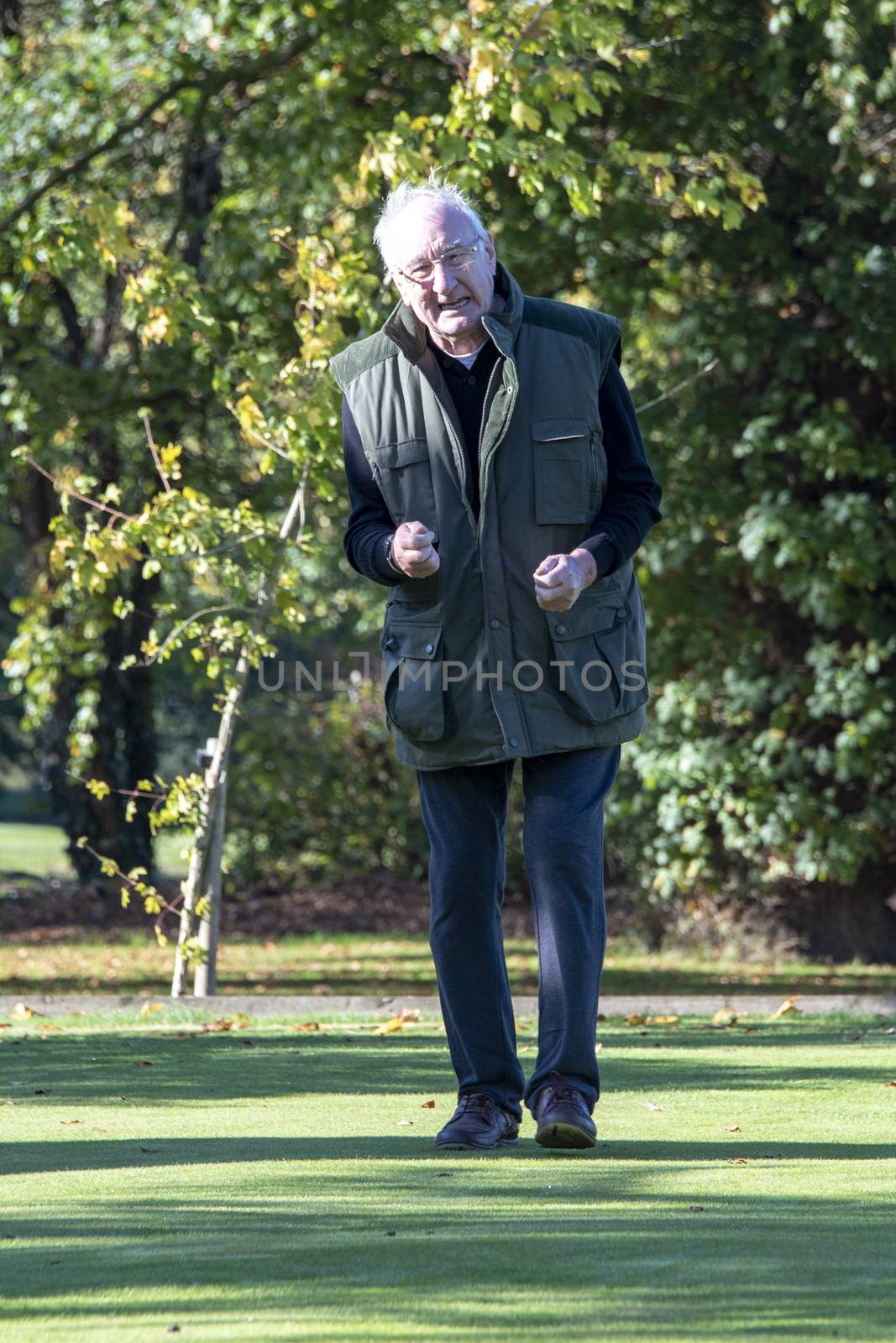 UK, Cheshire - Oct 2018: Elderly man standing outside in pain or angry