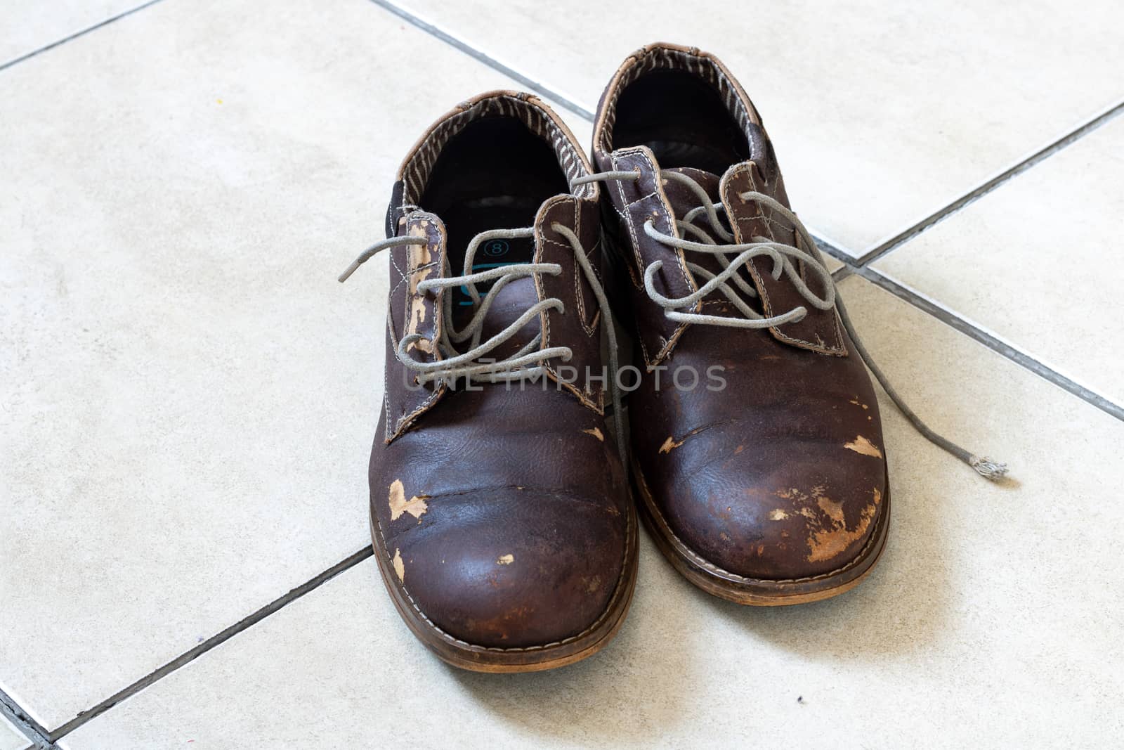 Scuffed and old leather shoes by phathisile