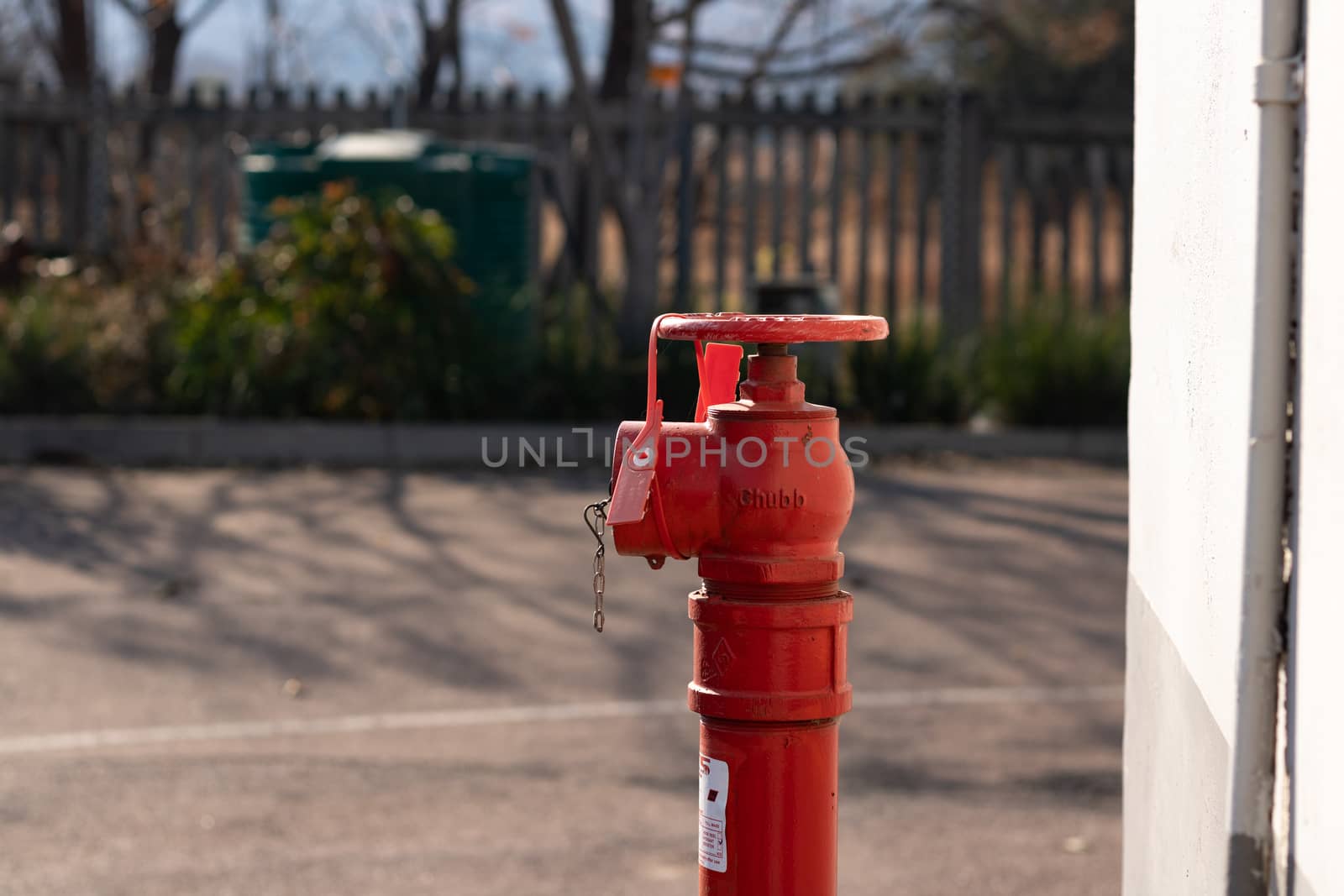 Red fire hydrant with a gren tank in the background by phathisile