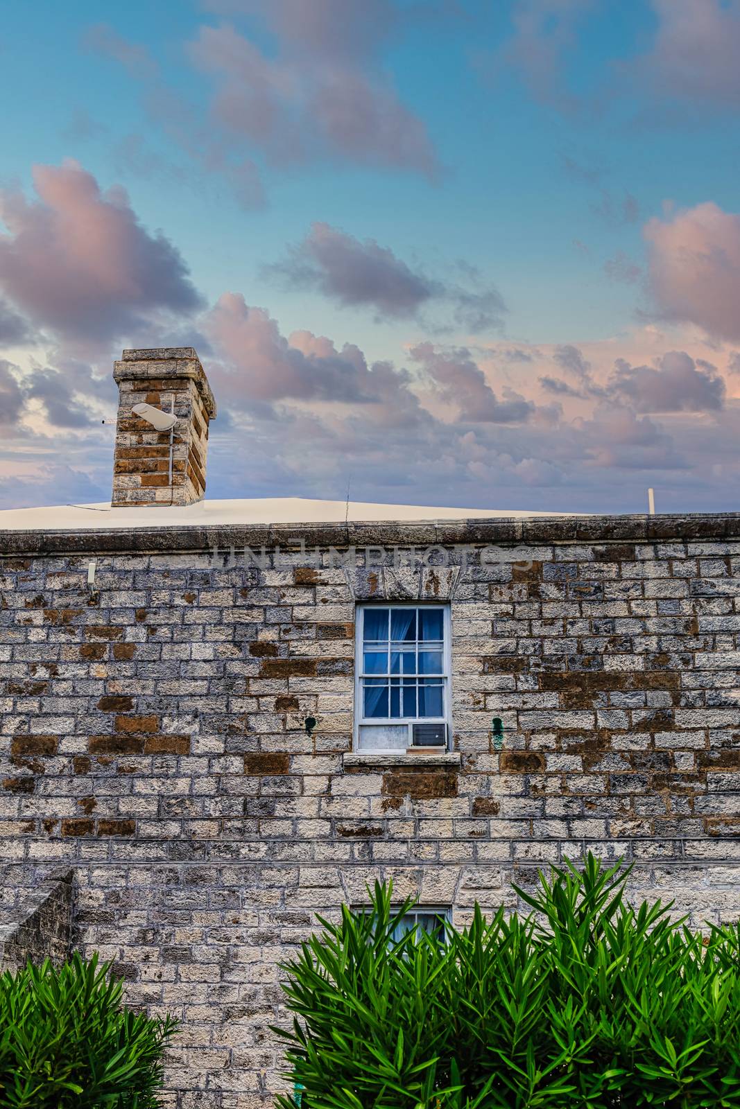 Window Air Conditioner in Old Stone Building at Dusk by dbvirago