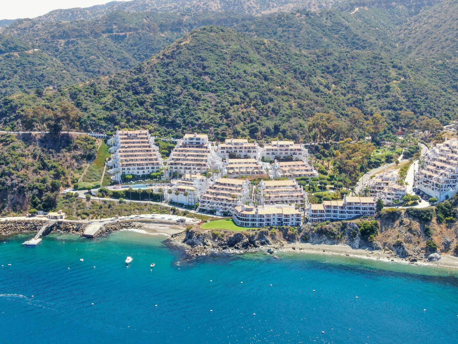 Aerial view of Hamilton Cove with apartment condo building on the cliff, Santa Catalina Island, famous tourist attraction in Southern California, USA