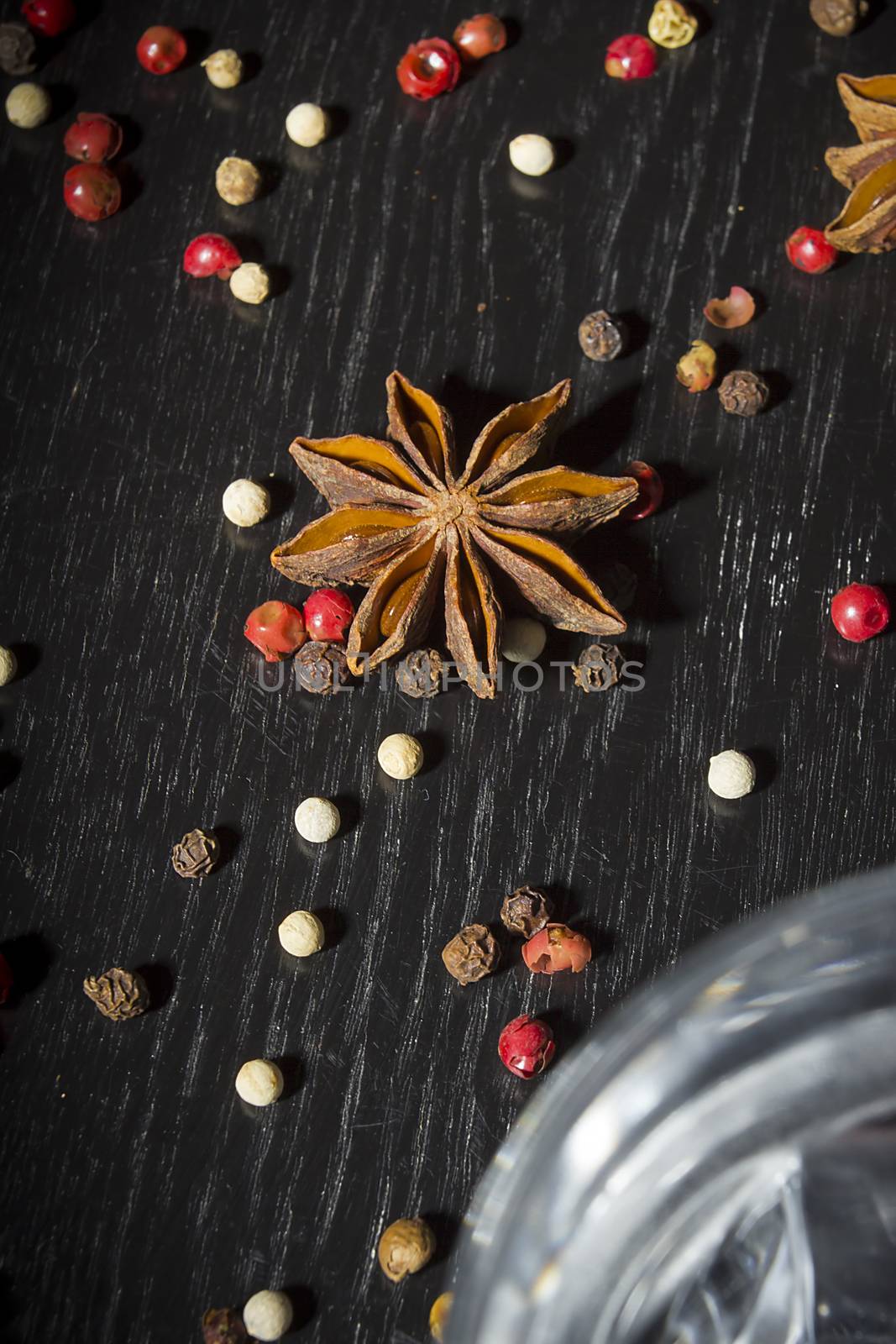 Anise vodka in a glass on a wooden surface