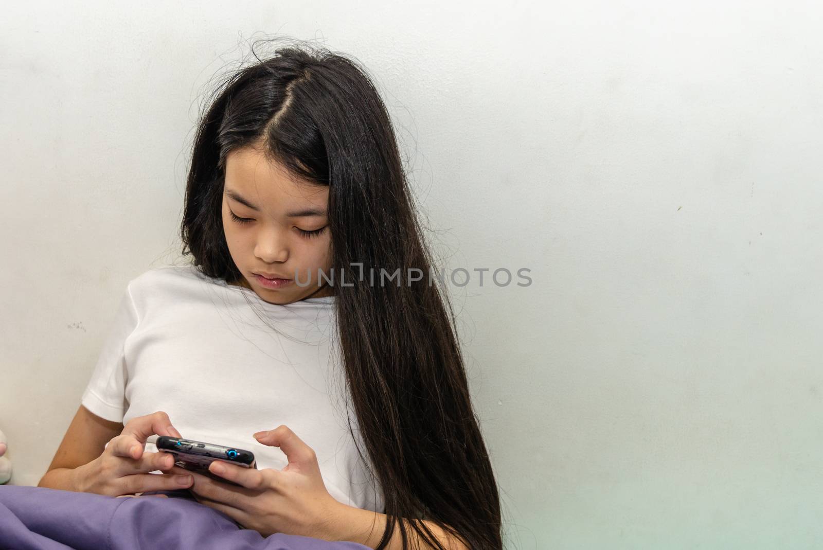  girl with long hair playing smartphone. by aoo3771