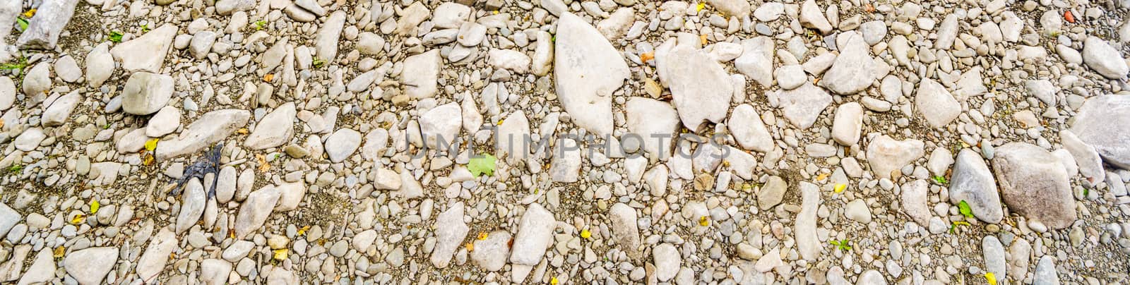 Panorama of Naturally polished river washed rocks and pebbles background by paddythegolfer