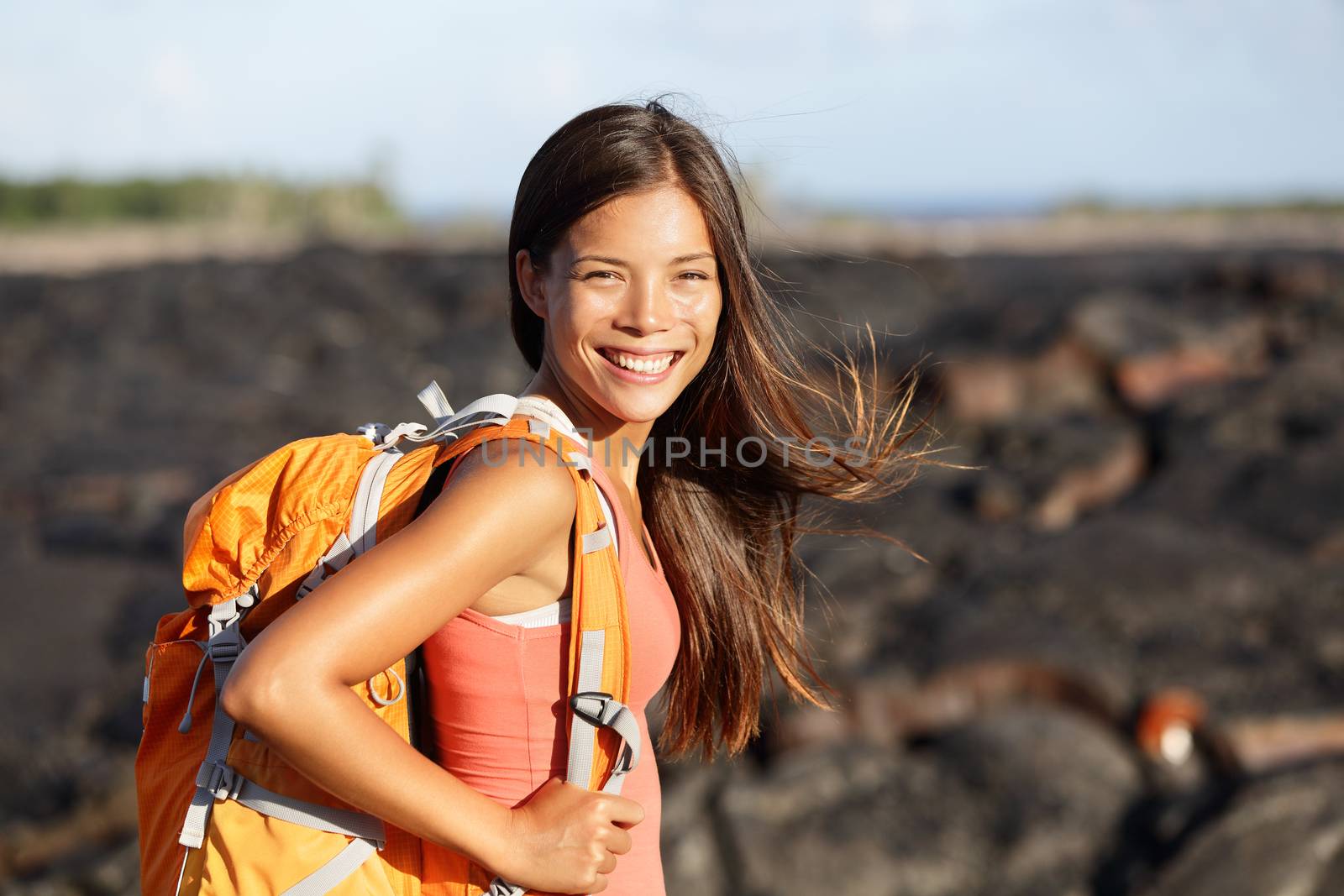 Hiking woman - hiker walking on lava field on Hawaii. Tourist on hike near Kilauea volcano around Hawaii volcanoes national park, USA.