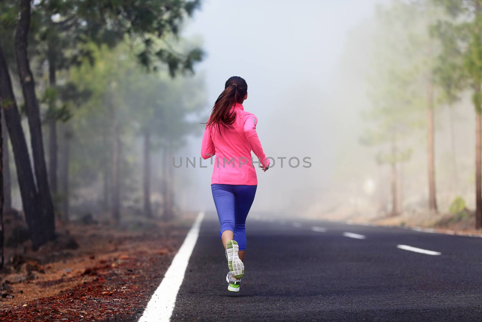 Healthy running runner woman workout on mountain road. Jogging female fitness girl working out training for marathon on forest road in amazing nature.