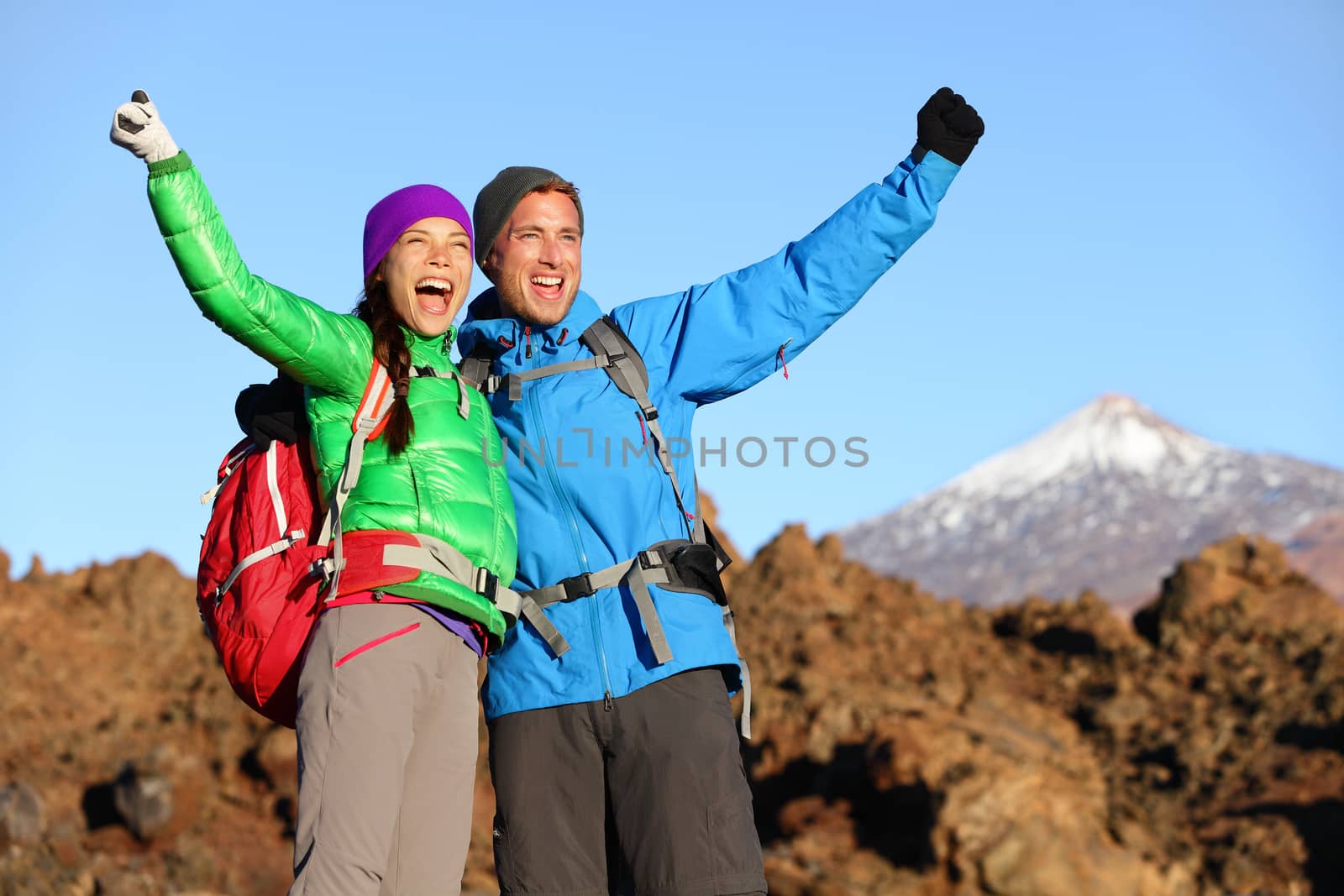 Happy celebrating hiking people at top by Maridav