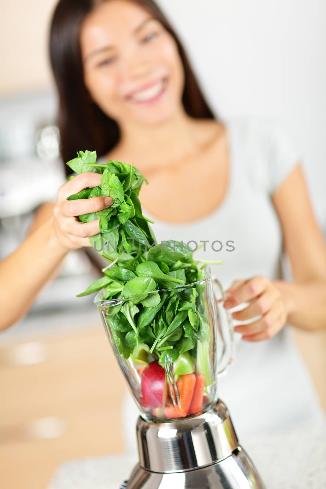 Green smoothie woman making vegetable smoothies by Maridav