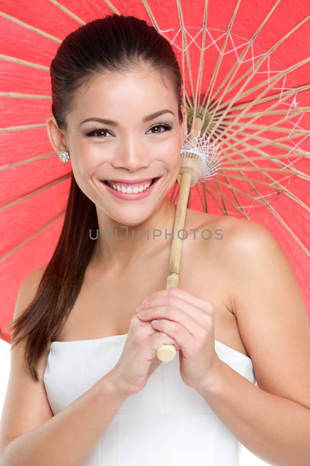 Chinese woman with traditional paper umbrella. Beautiful mixed race Chinese Asian / Caucasian girl smiling pretty