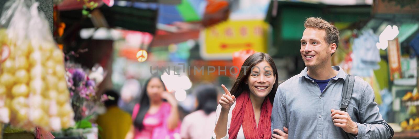 China food market travel people tourists shopping in alley street in Hong Kong. Asian woman Caucasian man couple traveling in Asia, chinese city lifestyle. Banner panorama. by Maridav