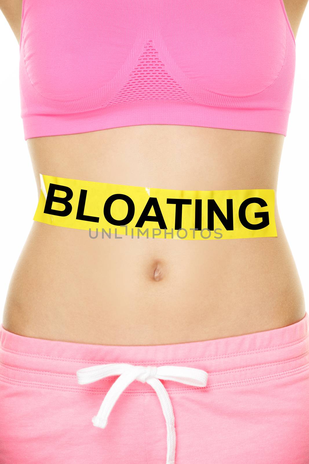 Bloating in stomach abdomen. BLOATING text written on female stomach. Bloated due to food diet conceptual image.