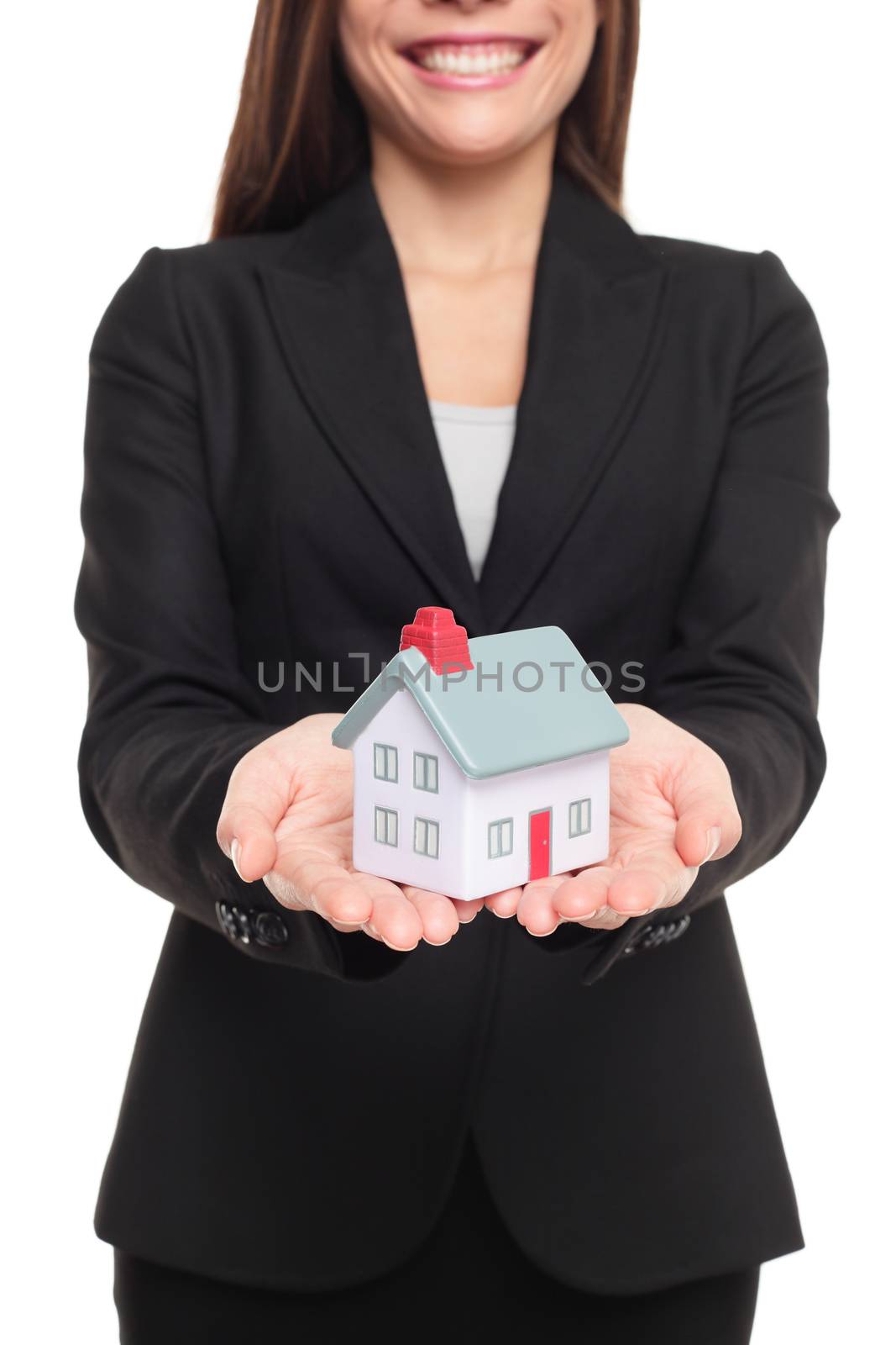 Real estate agent showing new house in mini size. New home owner concept. Realtor showing holding house model. Buying new home conceptual image with business woman in suit isolated on white background