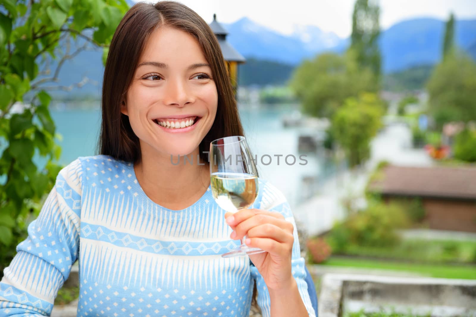 Happy woman smiling as she toasts with champagne by Maridav