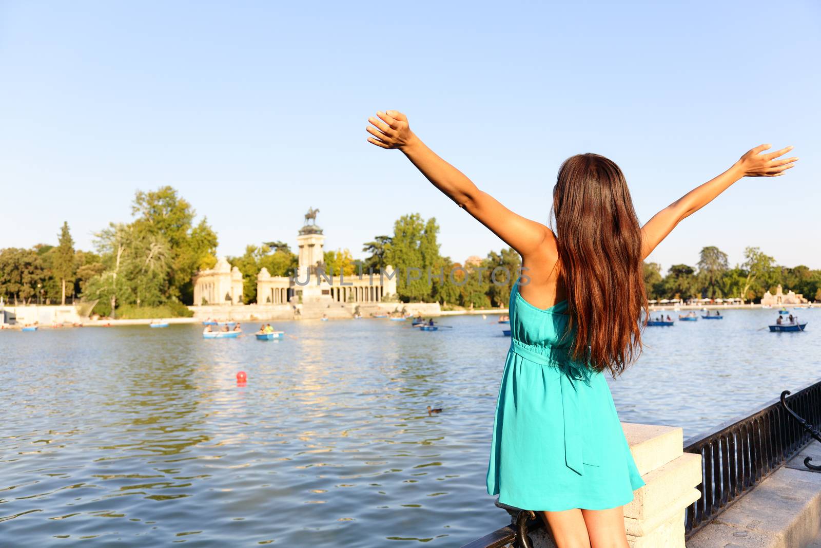 Happy success woman in Madrid park El Retiro by Maridav