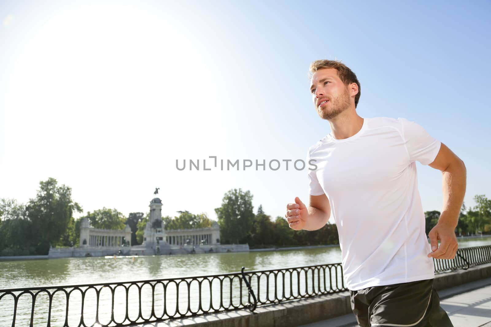 Jogging man running in city park El Retiro Madrid by Maridav