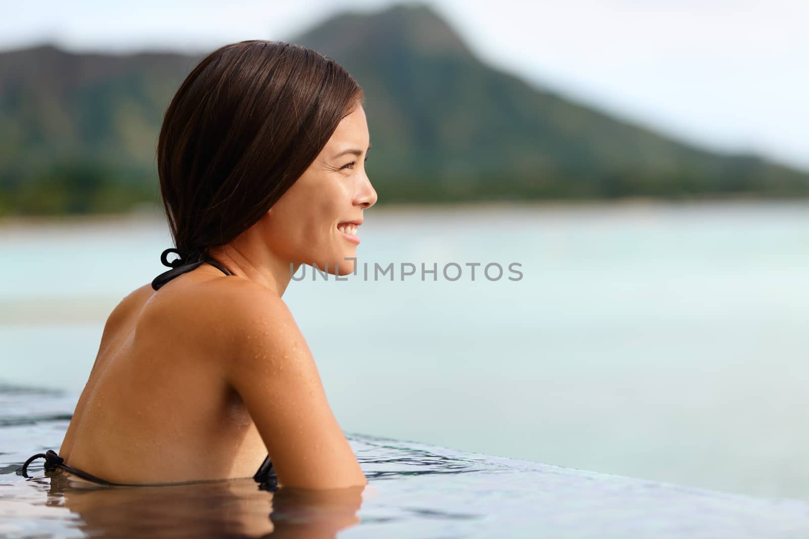 Vacation woman swimming at infinity pool on Hawaii by Maridav