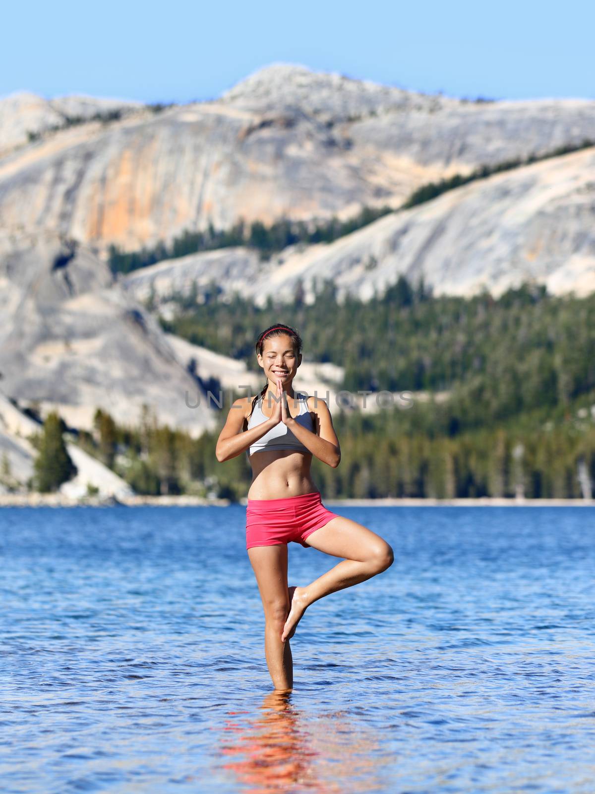 Yoga meditation woman meditating in nature lake by Maridav