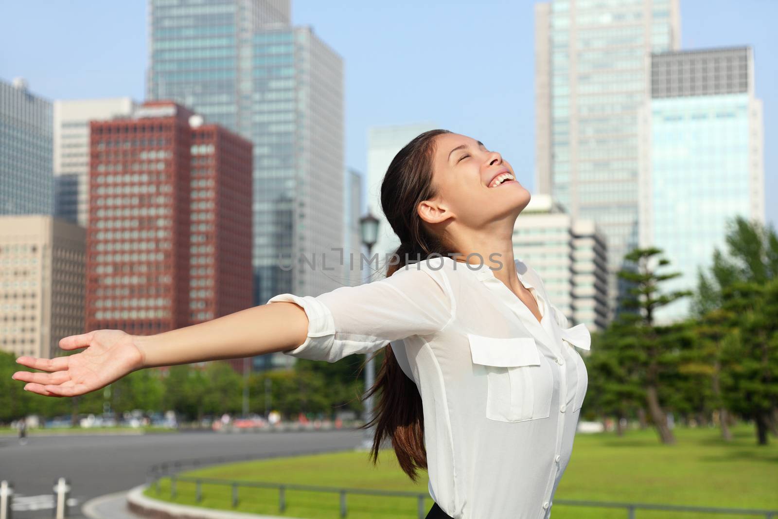 Happy free Asian business woman in Tokyo, Japan by Maridav