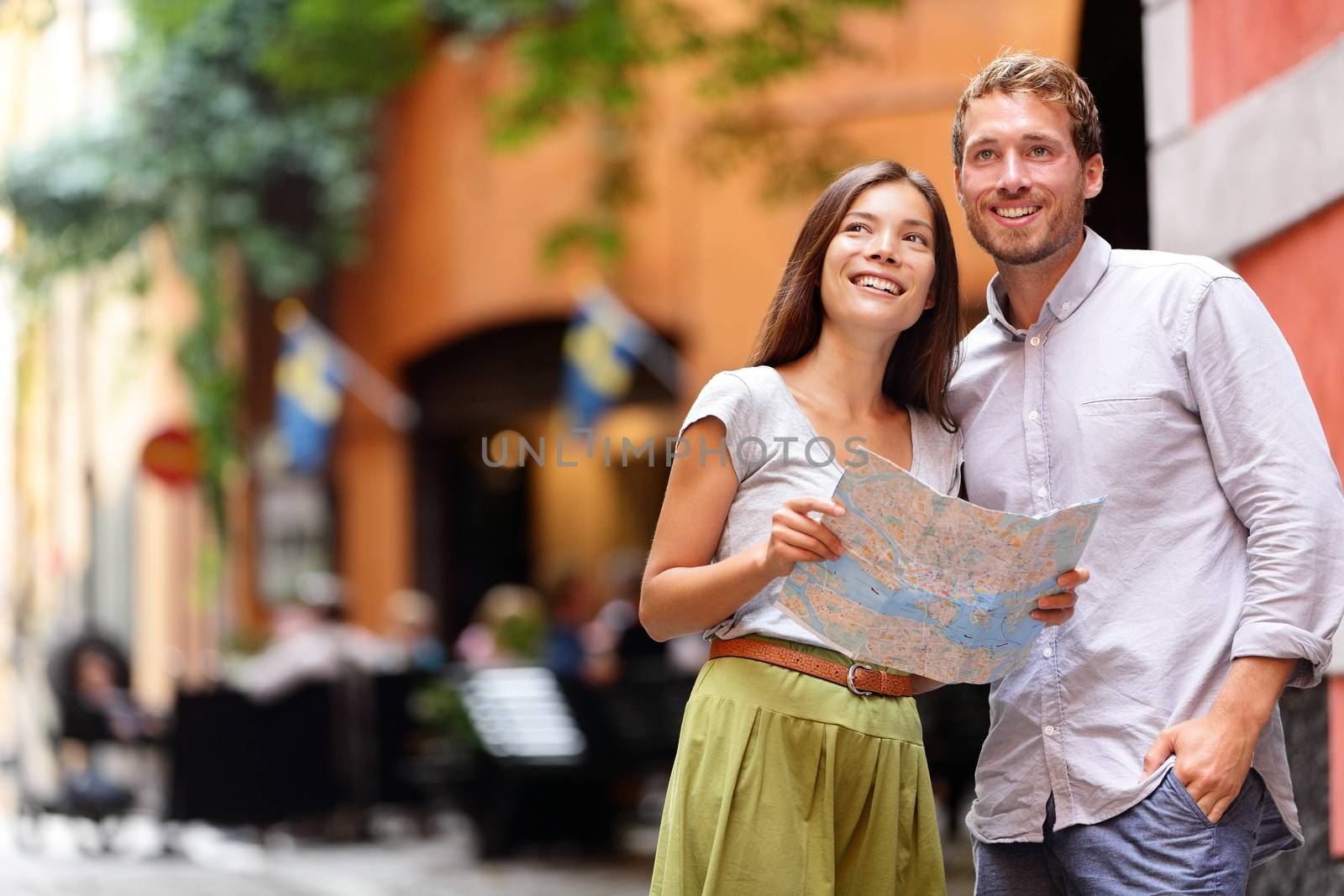 Stockholm tourists couple with map in Gamla Stan by Maridav