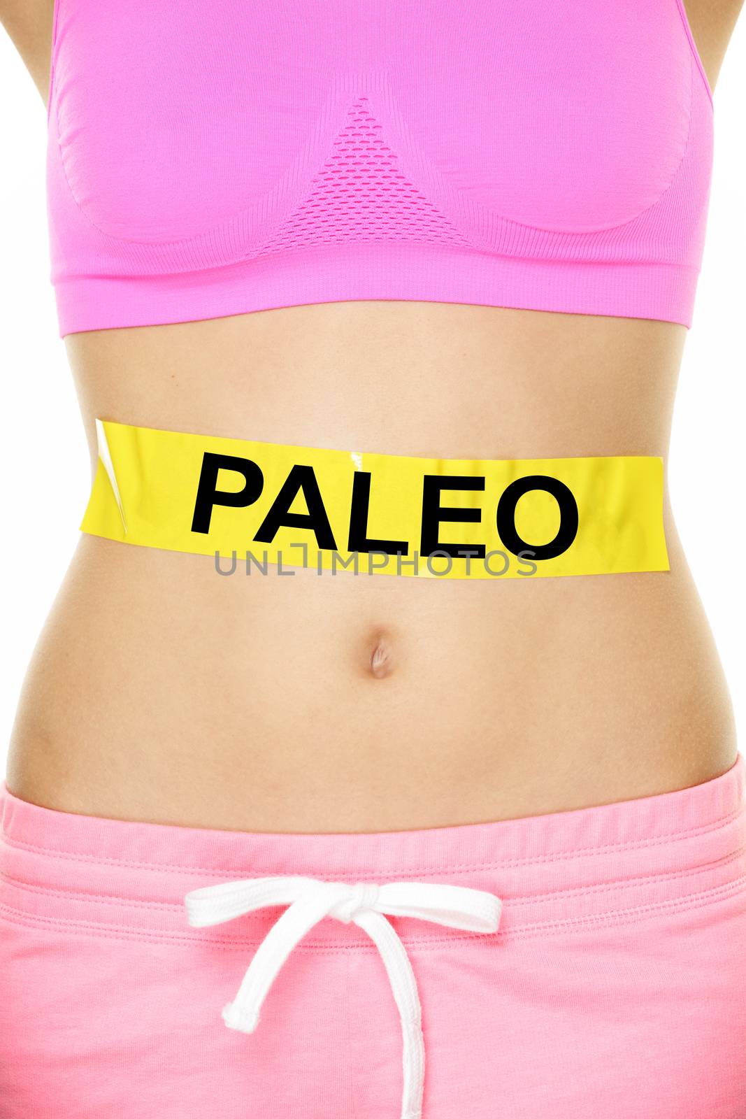 Paleo diet concept - closeup of woman's stomach to show eating concept. New trend in nutrition based on hunter gatherer consumption of proteins. Yellow label as warning or caution applied on body.
