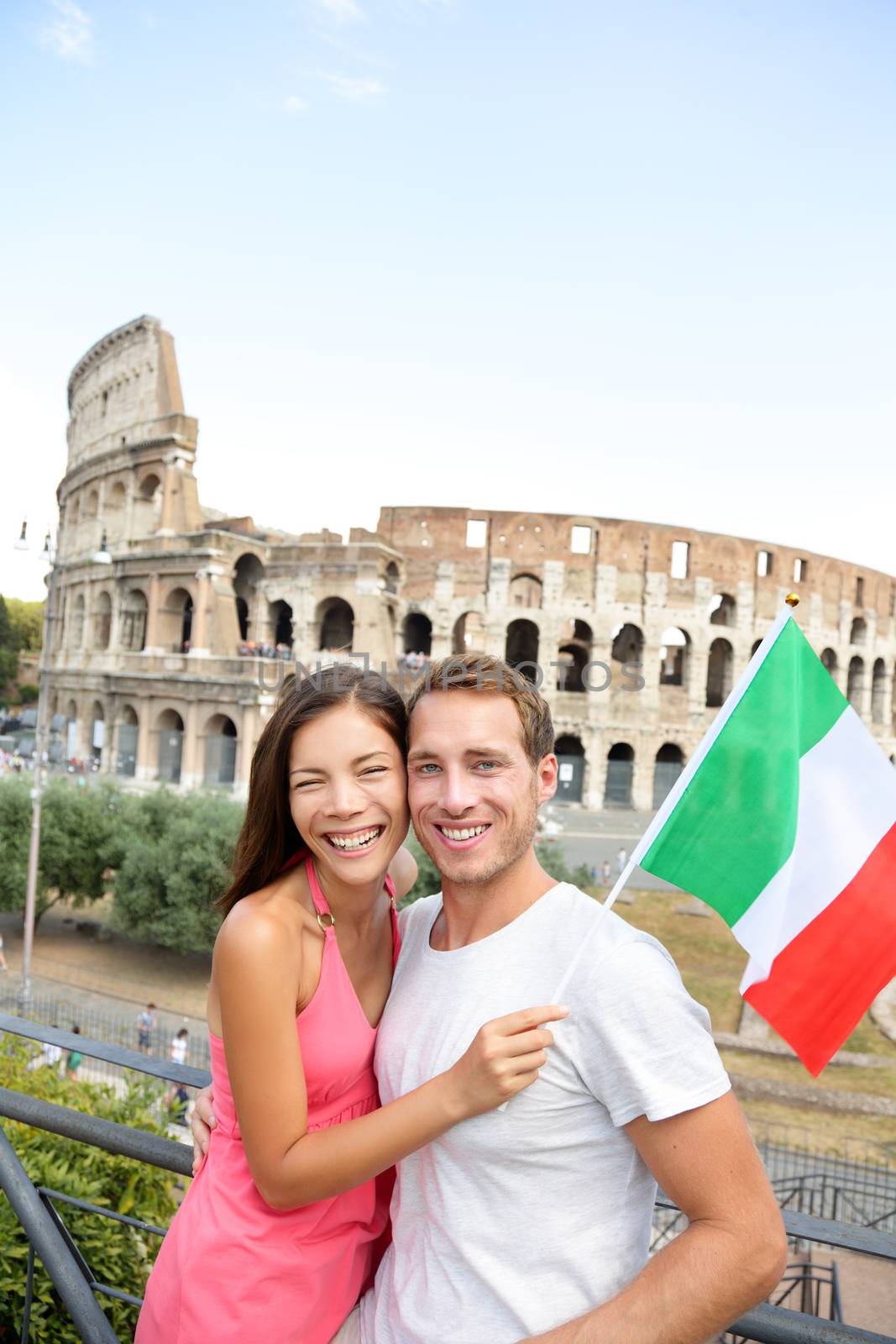 Happy tourists in front of Coliseum, Rome, Italy by Maridav