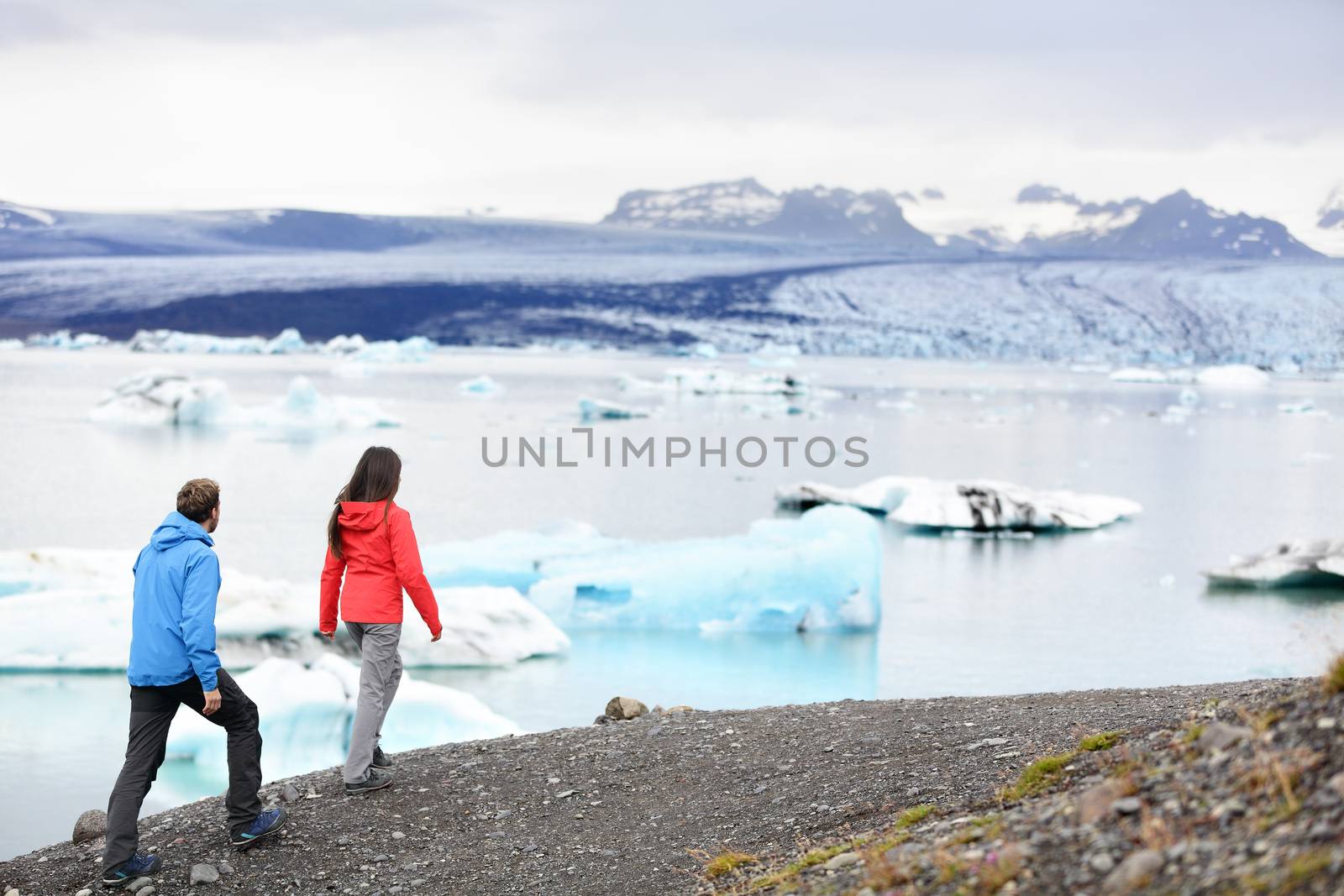 Hiking couple on Iceland Jokulsarlon glacier lake by Maridav