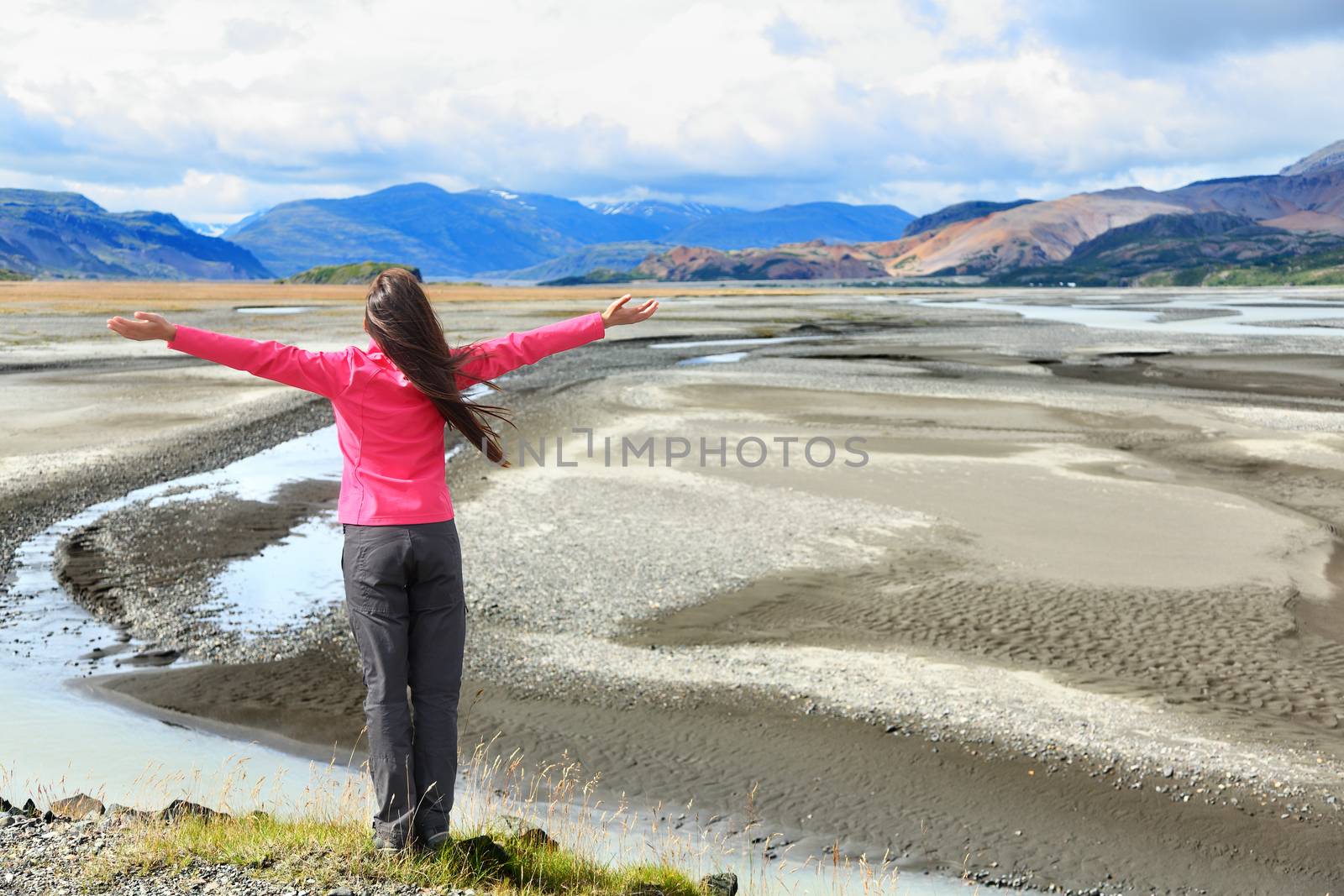 Woman enjoying view of Iceland black sand dunes by Maridav