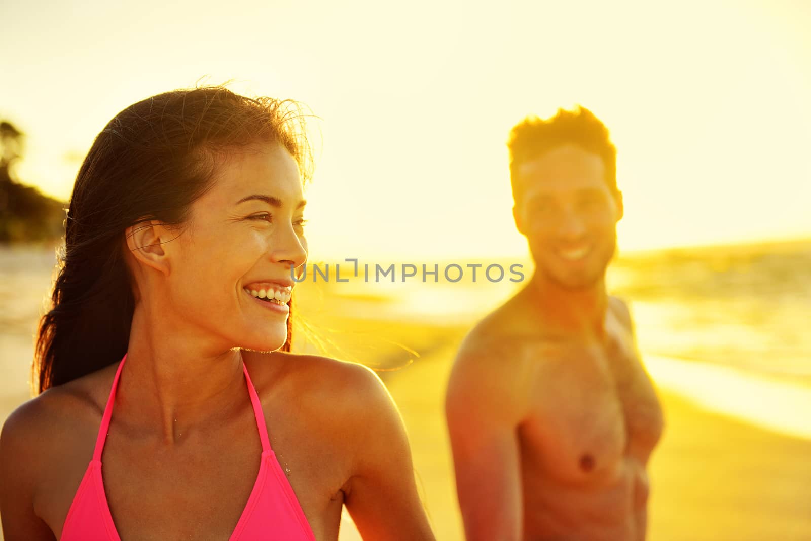 Happy multicultural couple on beach vacations by Maridav