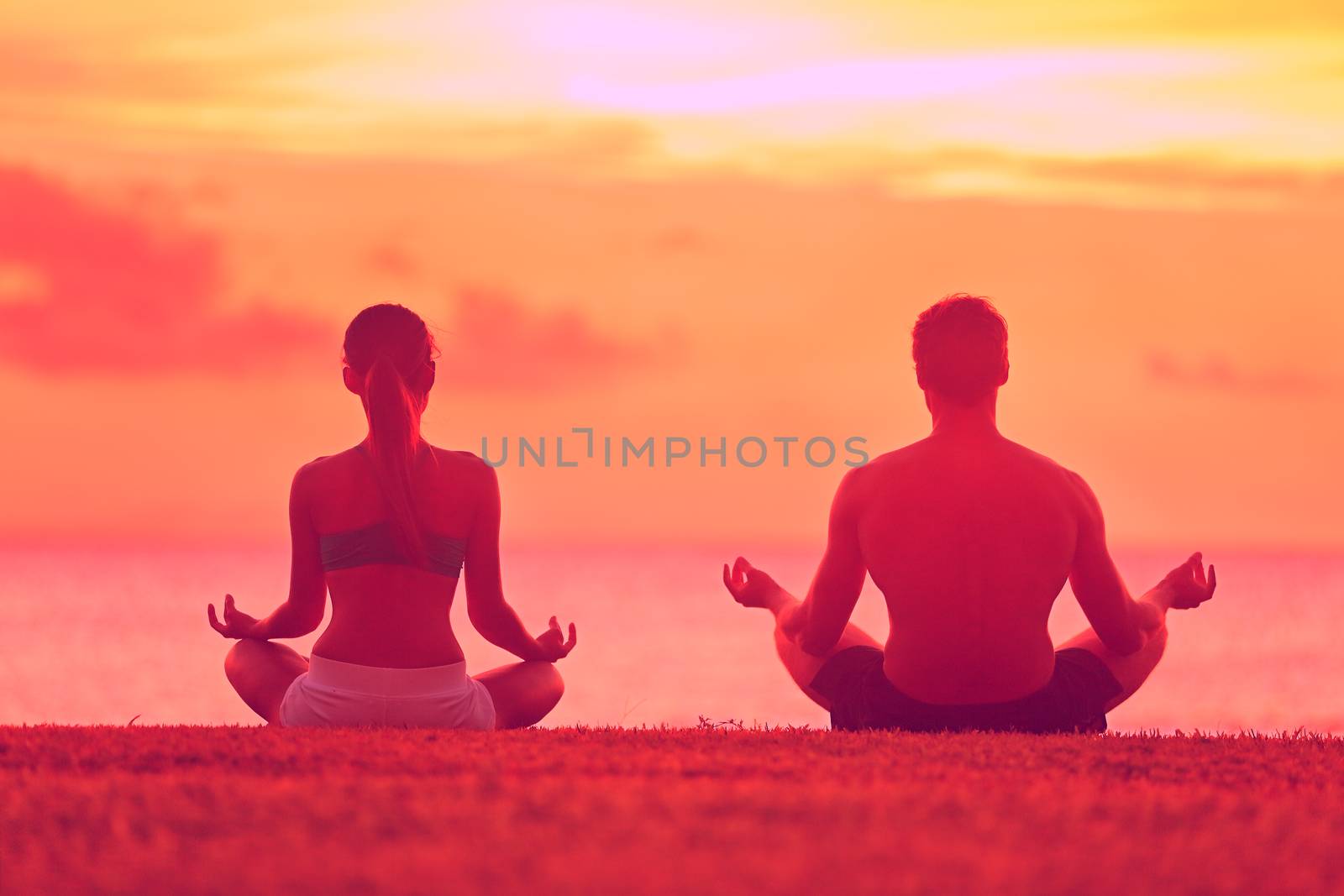 Meditation yoga couple meditating at beach sunset by Maridav