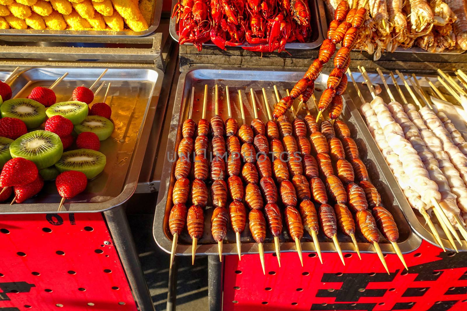 Exotic snacks and desserts can be found in this famous market Donghuamen Night food market near Wangfujing street, Beijing, China