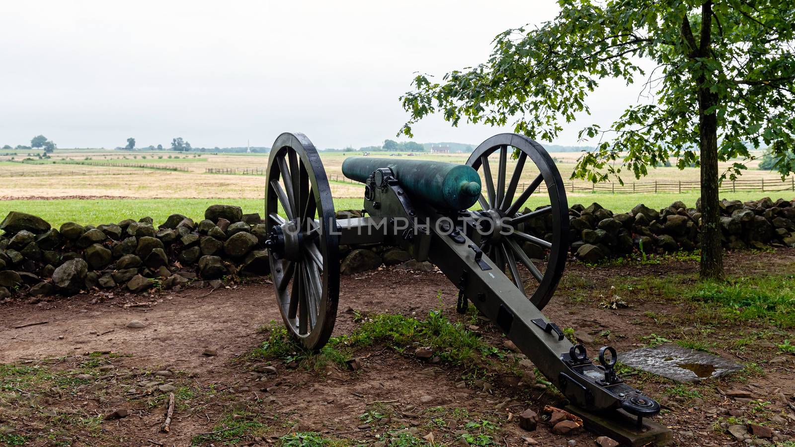 A Civil War era cannon is placed behind a stone wall in Gettysburg, PA