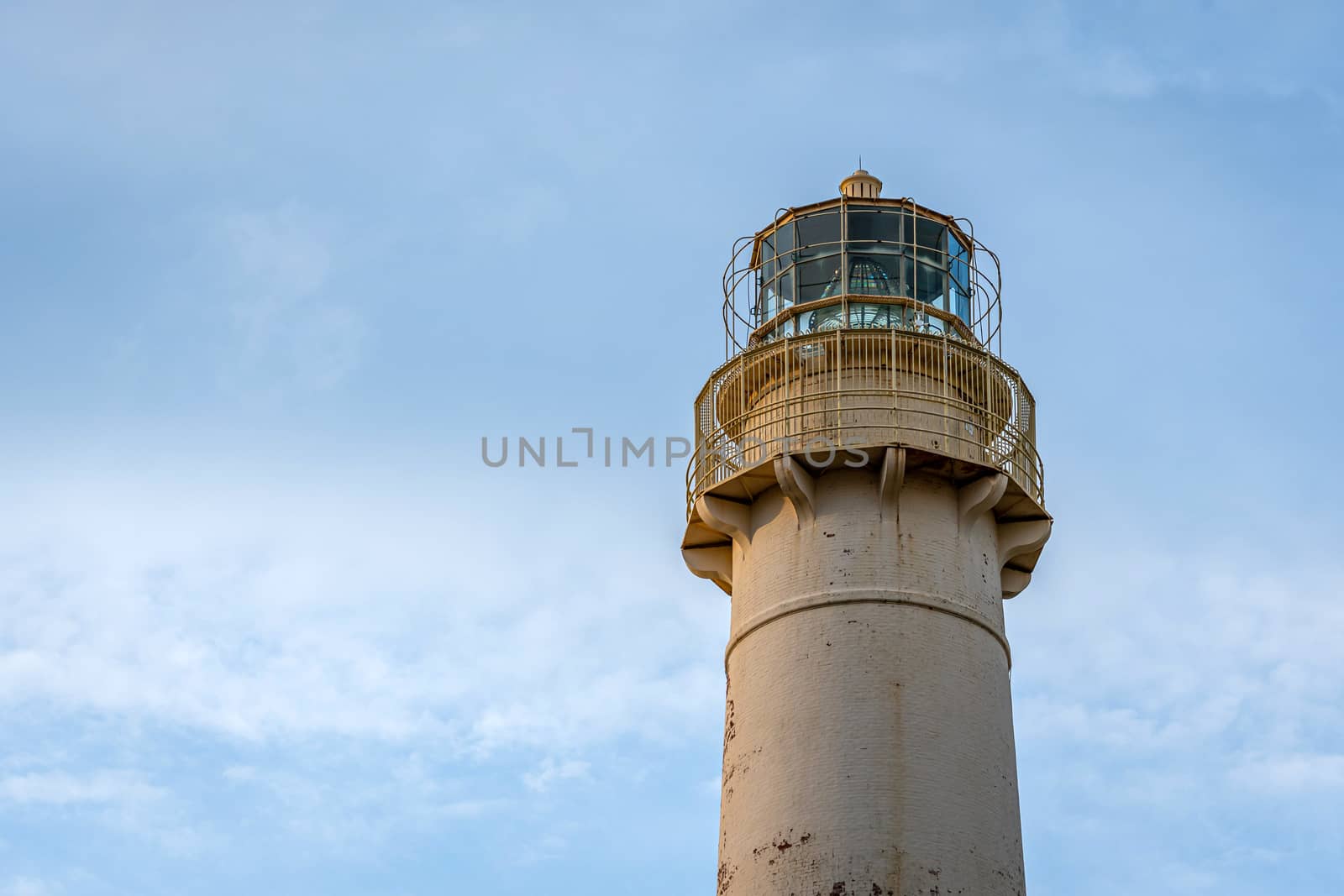 Lighthouse on a light blue sky background