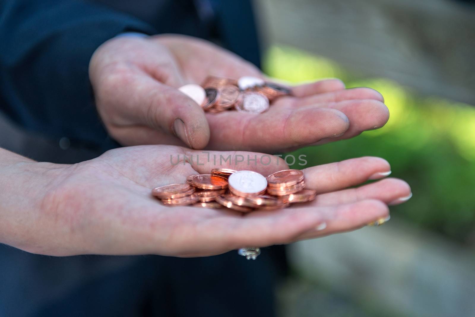 The bride and groom there with a handful of coins.