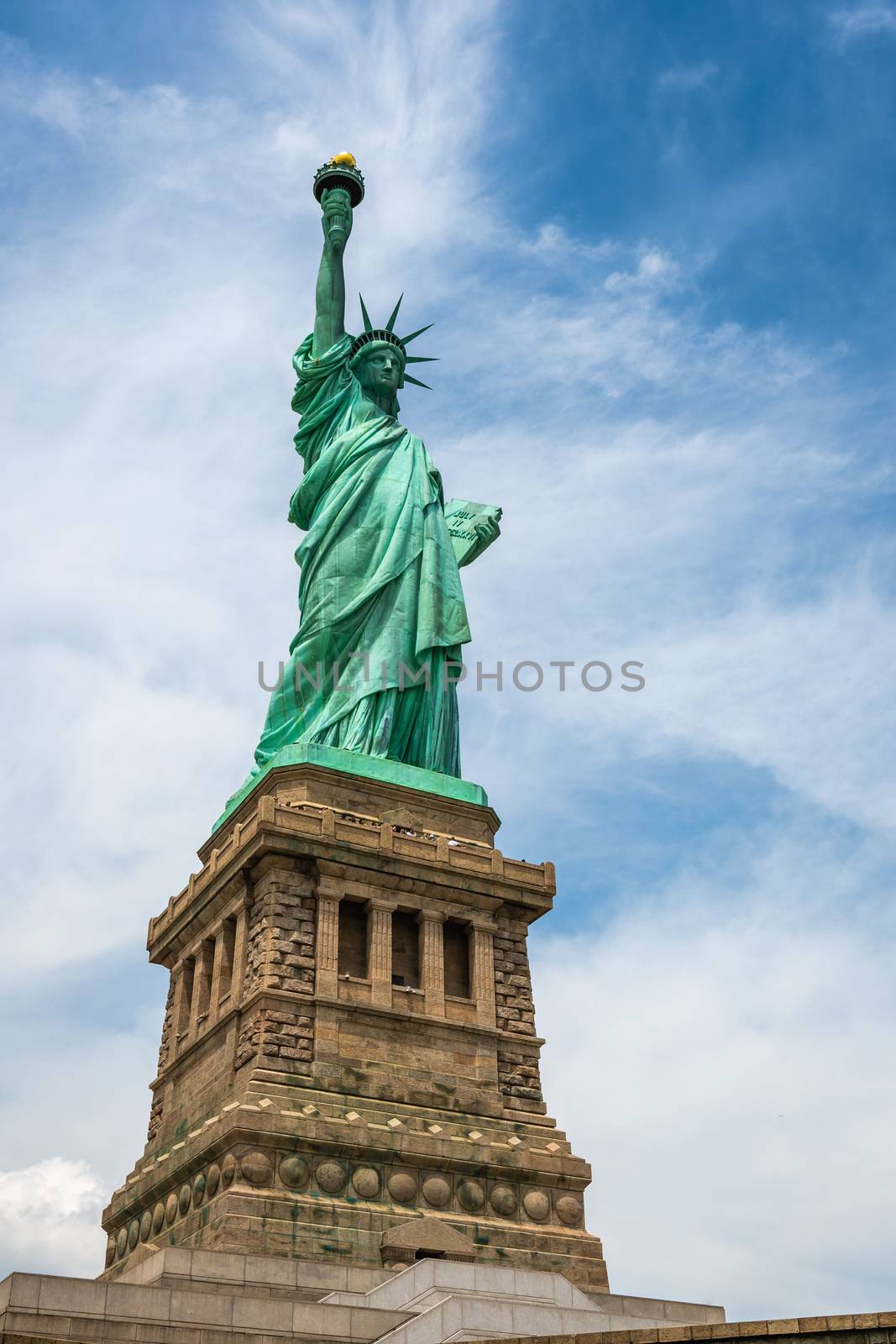 Statue of Liberty on Liberty Island closeup with blue sky in New York City Manhattan - Image