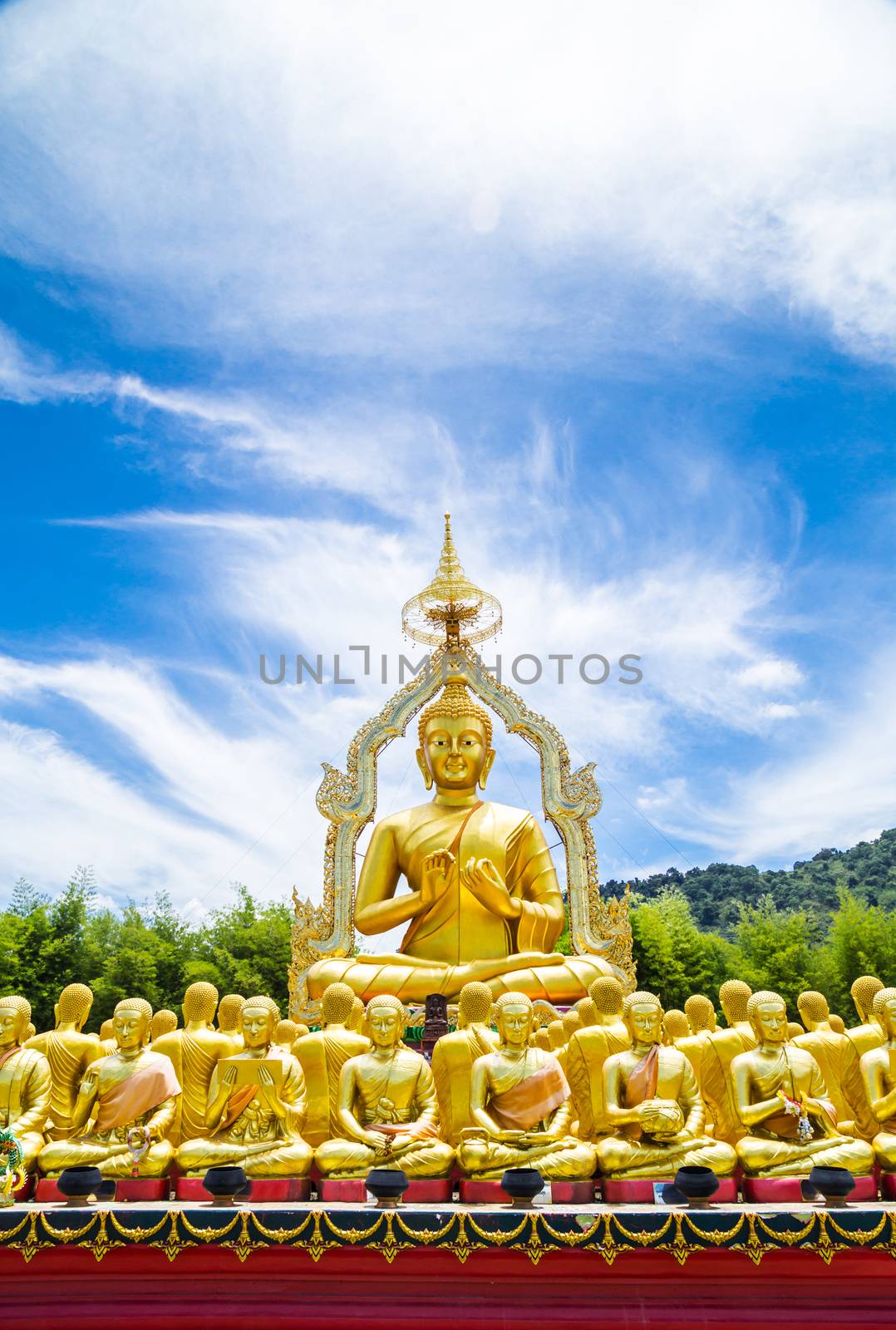 Row of disciple statues surrounding big buddha statue in public to the general public worship worship of Nakhon Nayok, Thailand.