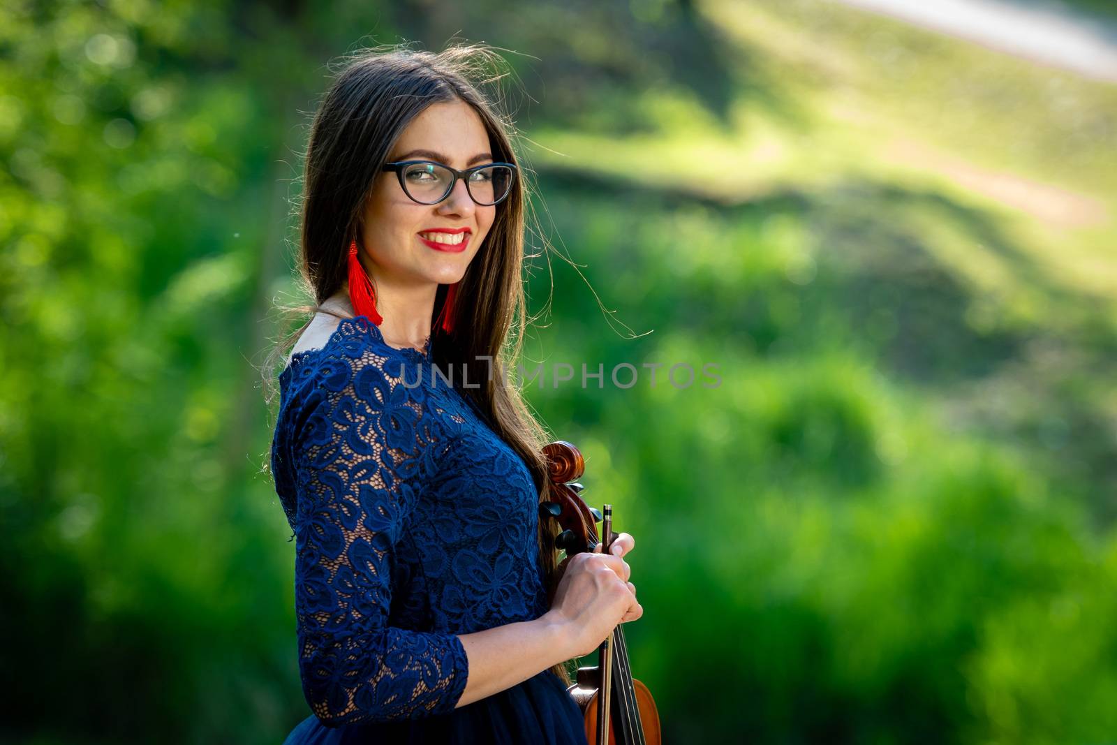 Young woman  with violin at park. Shallow depth of field.