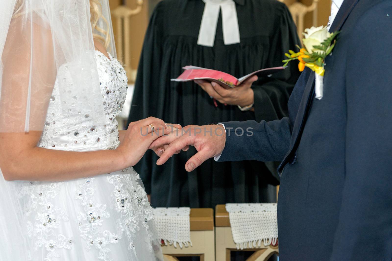 The bride and groom exchange with rings.