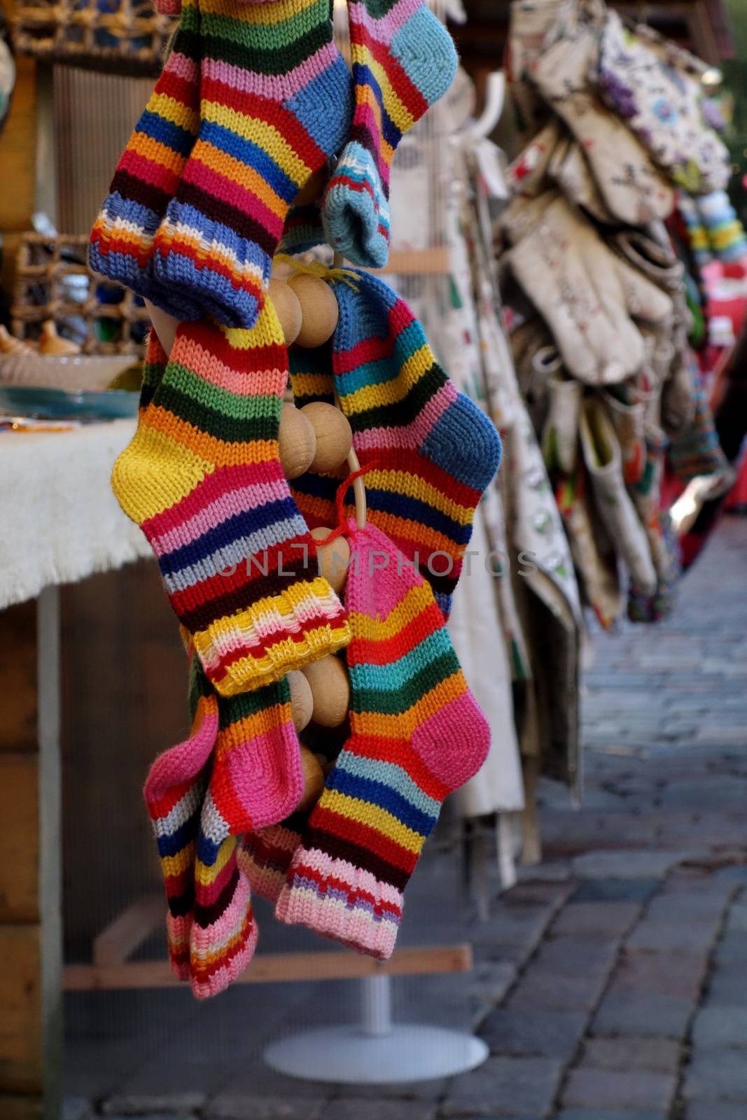 In the market a wide selection of different colored hand-knitted socks.