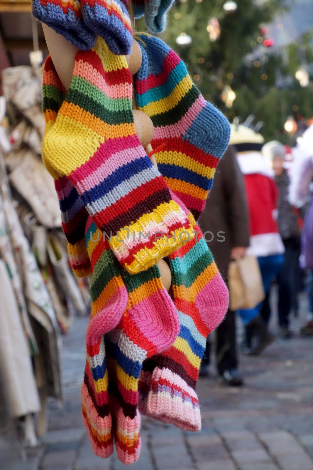 In the market a wide selection of different colored hand-knitted socks.