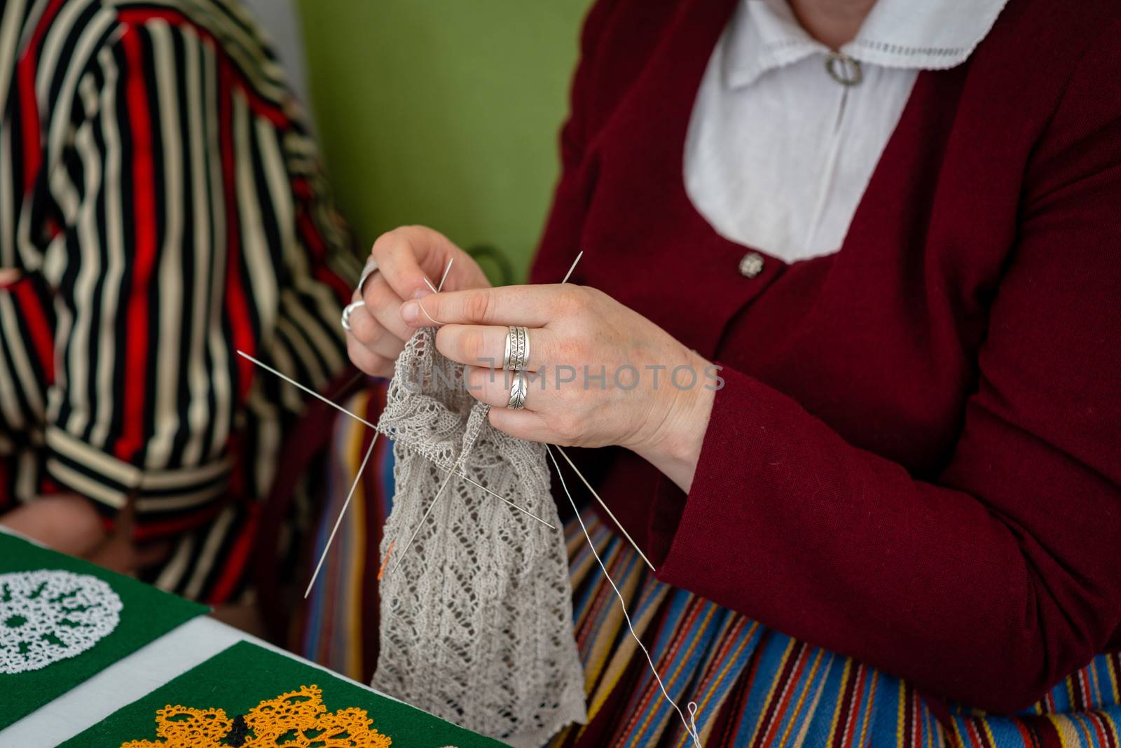 Close up of the hands of an elderly woman knitting. - Image